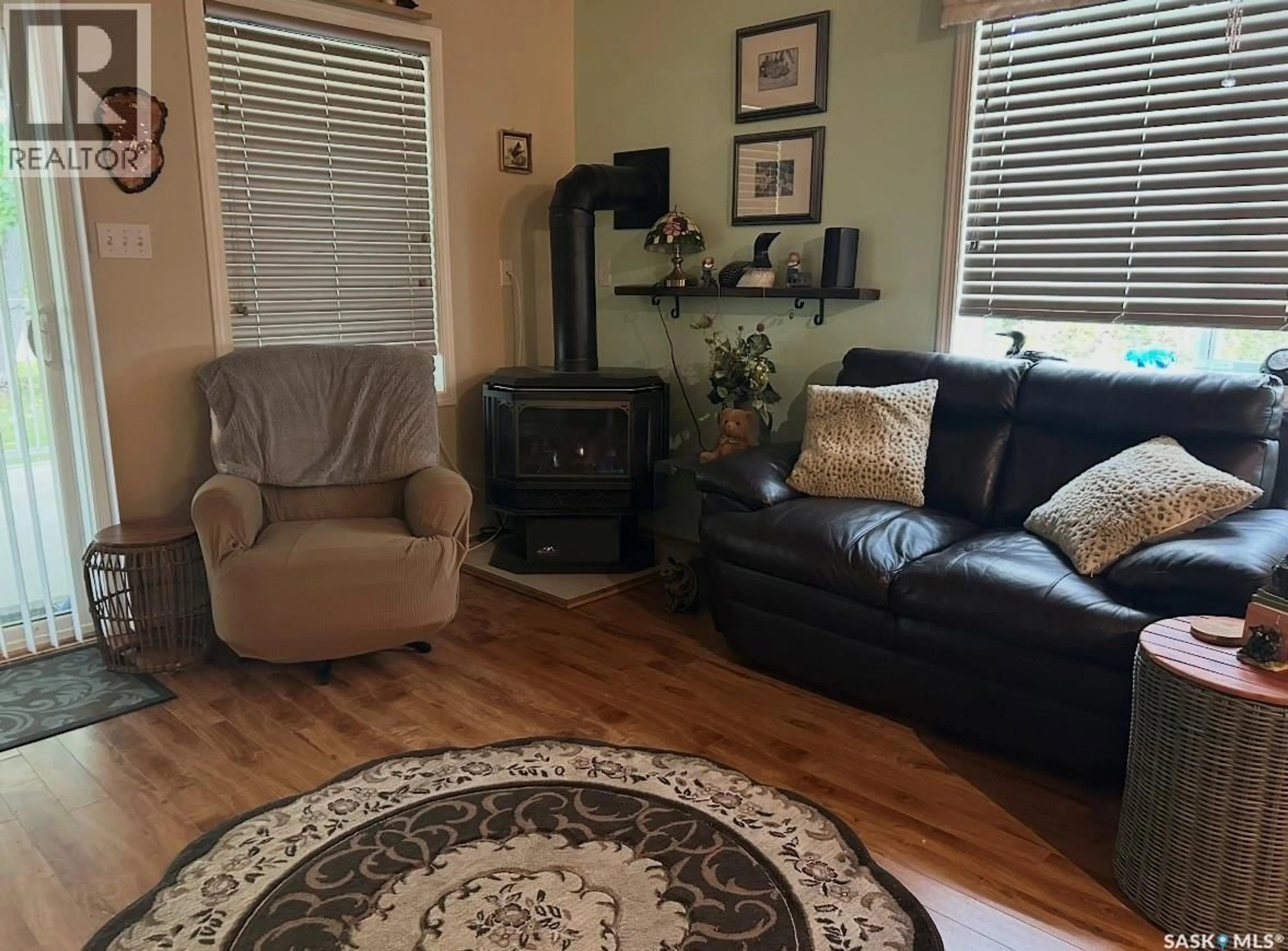 Living room with furniture, wood/laminate floor for 134 SUNRIDGE ROAD, Pebble Baye Saskatchewan S0J2G0