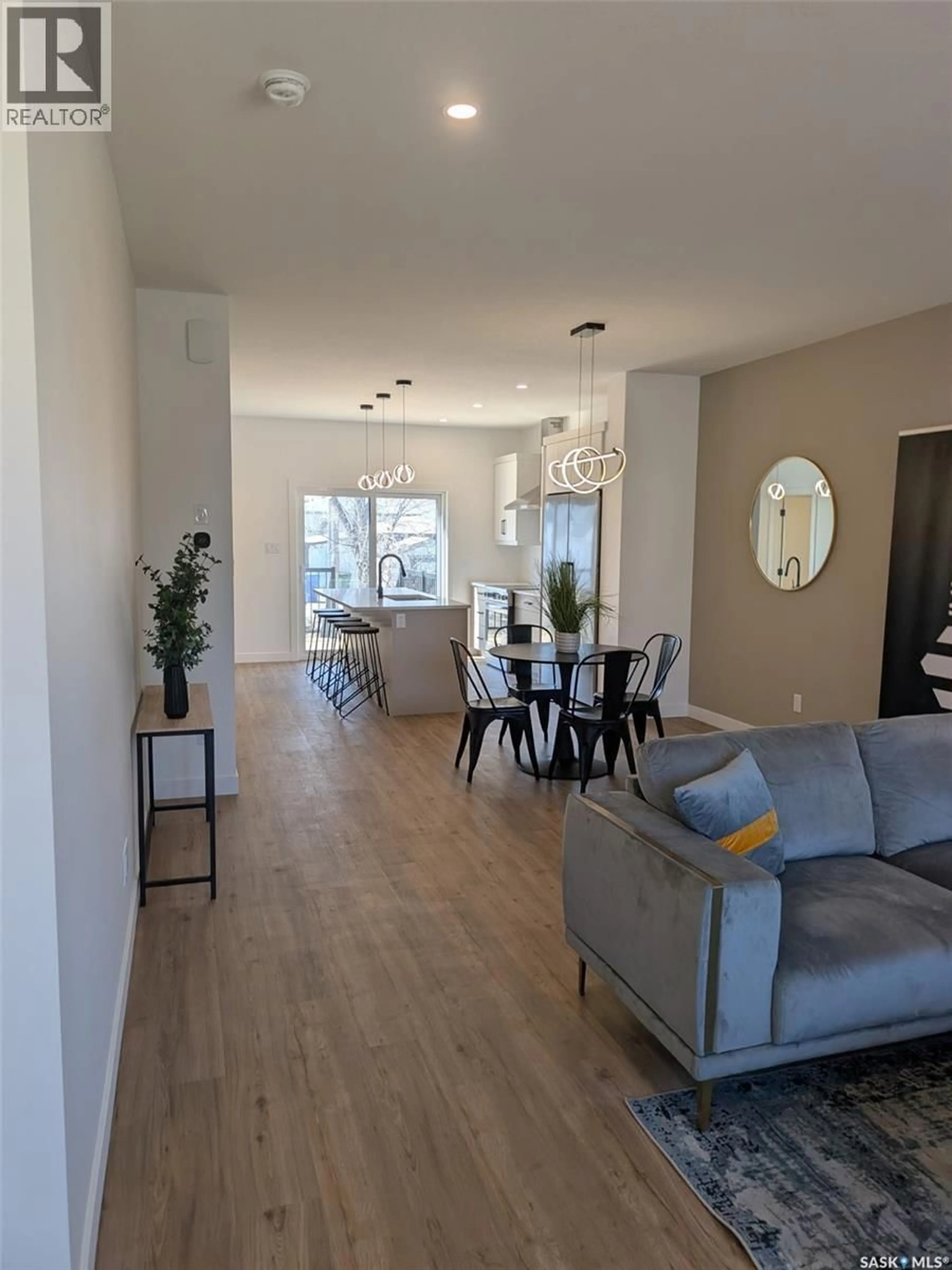 Living room with furniture, wood/laminate floor for 2460 LINDSAY STREET, Regina Saskatchewan S4N3C6
