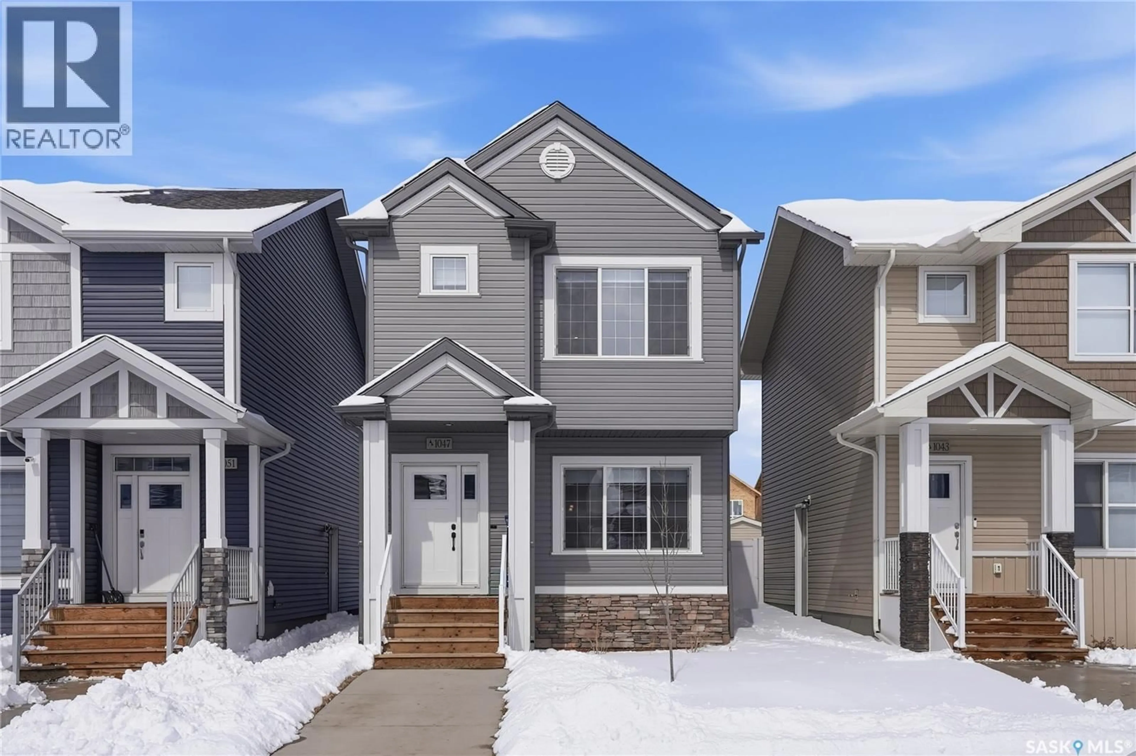 Home with vinyl exterior material, street for 1047 BRIGHTON GATE, Saskatoon Saskatchewan S7V1S5