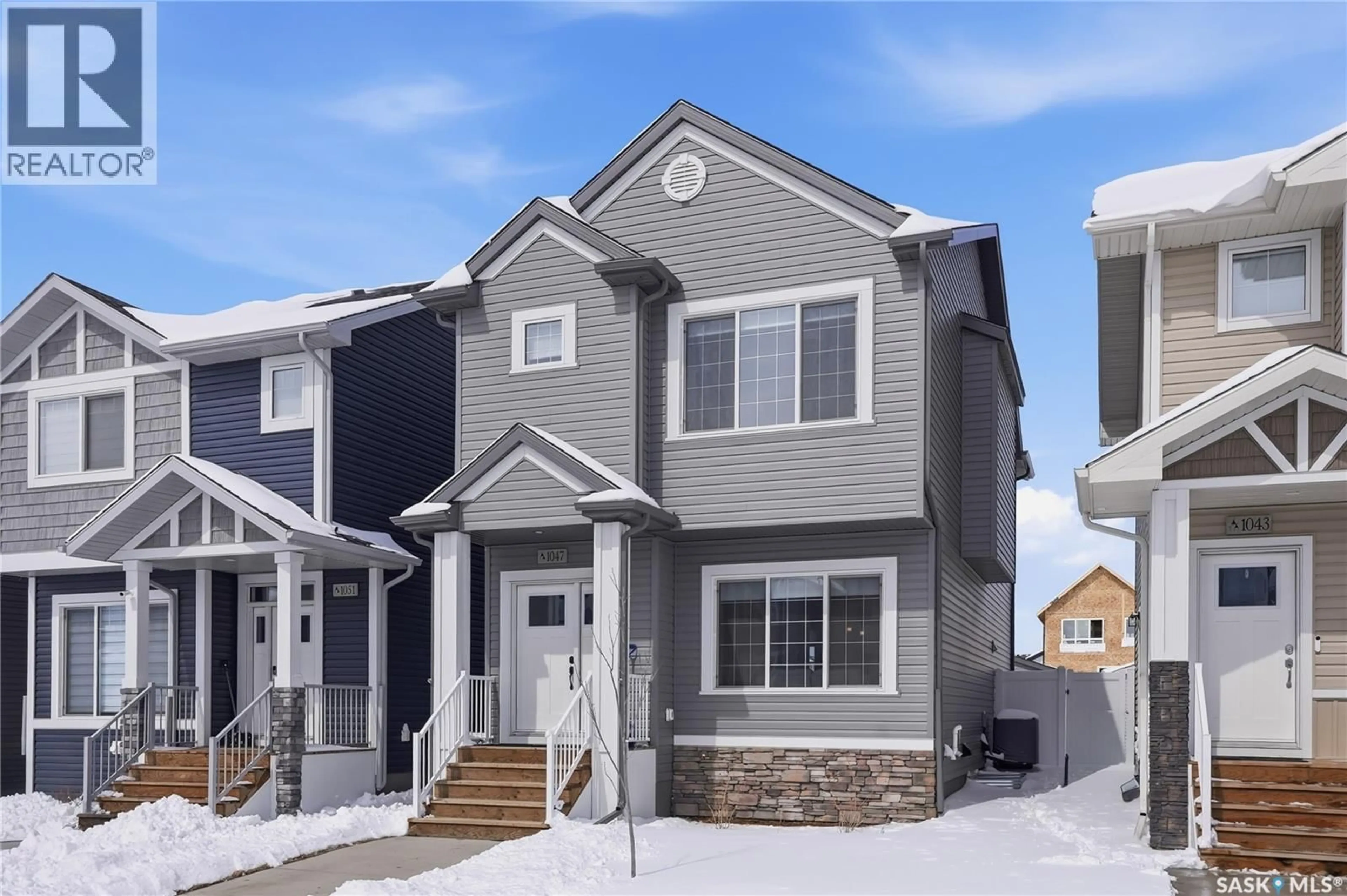 Home with vinyl exterior material, street for 1047 BRIGHTON GATE, Saskatoon Saskatchewan S7V1S5