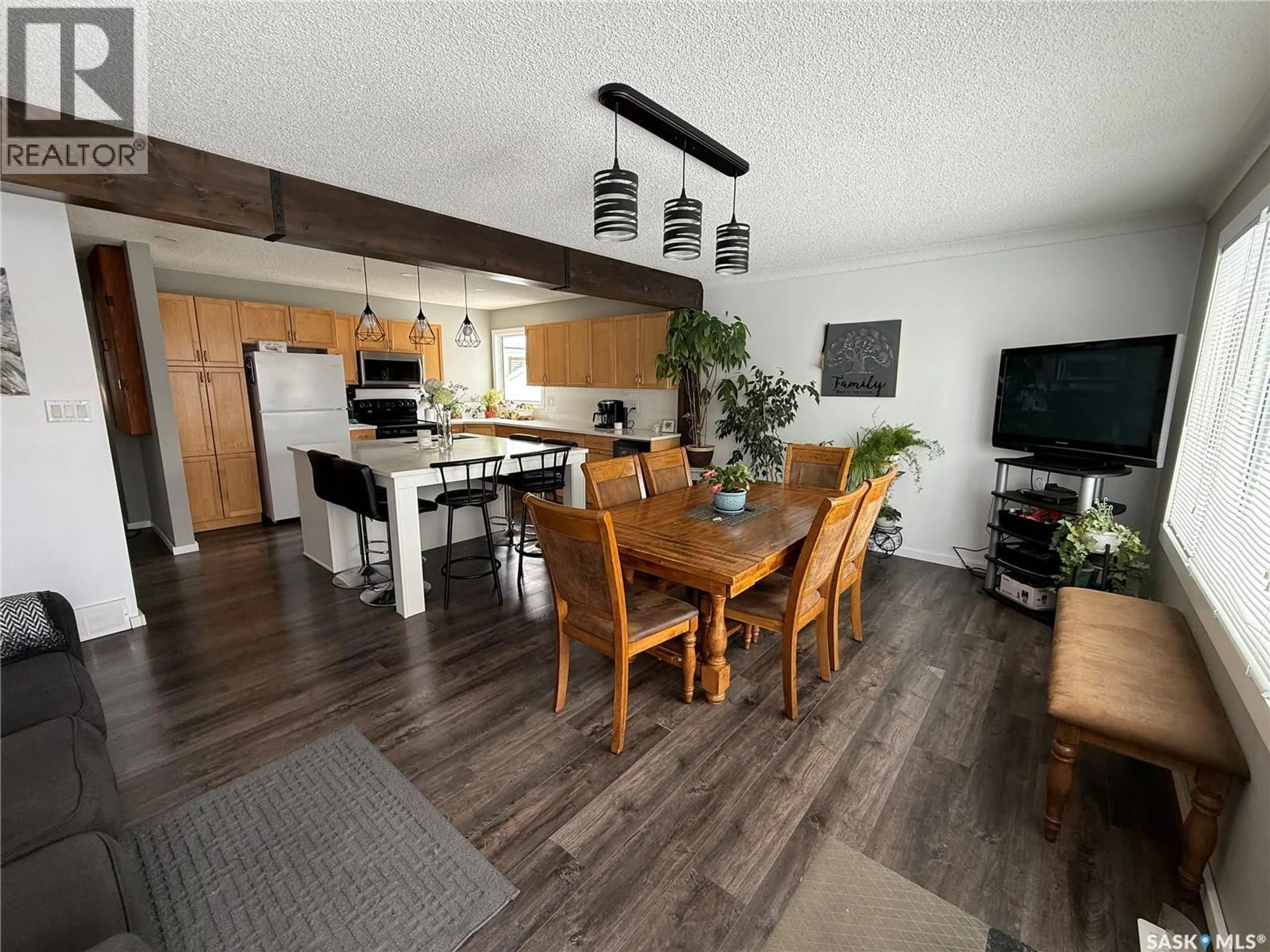 Open concept kitchen, wood/laminate floor for 113 7TH AVENUE, Weyburn Saskatchewan S4H1Z3