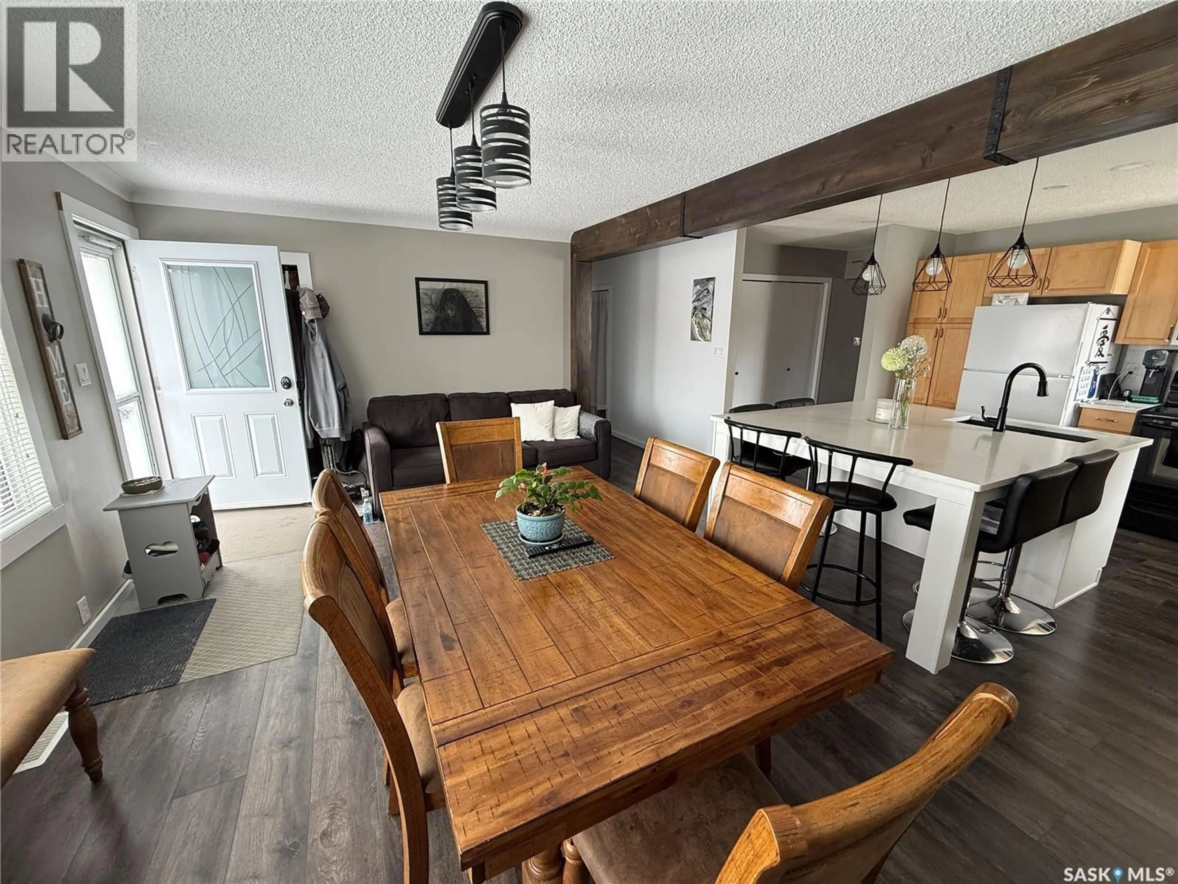 Dining room, wood/laminate floor for 113 7TH AVENUE, Weyburn Saskatchewan S4H1Z3