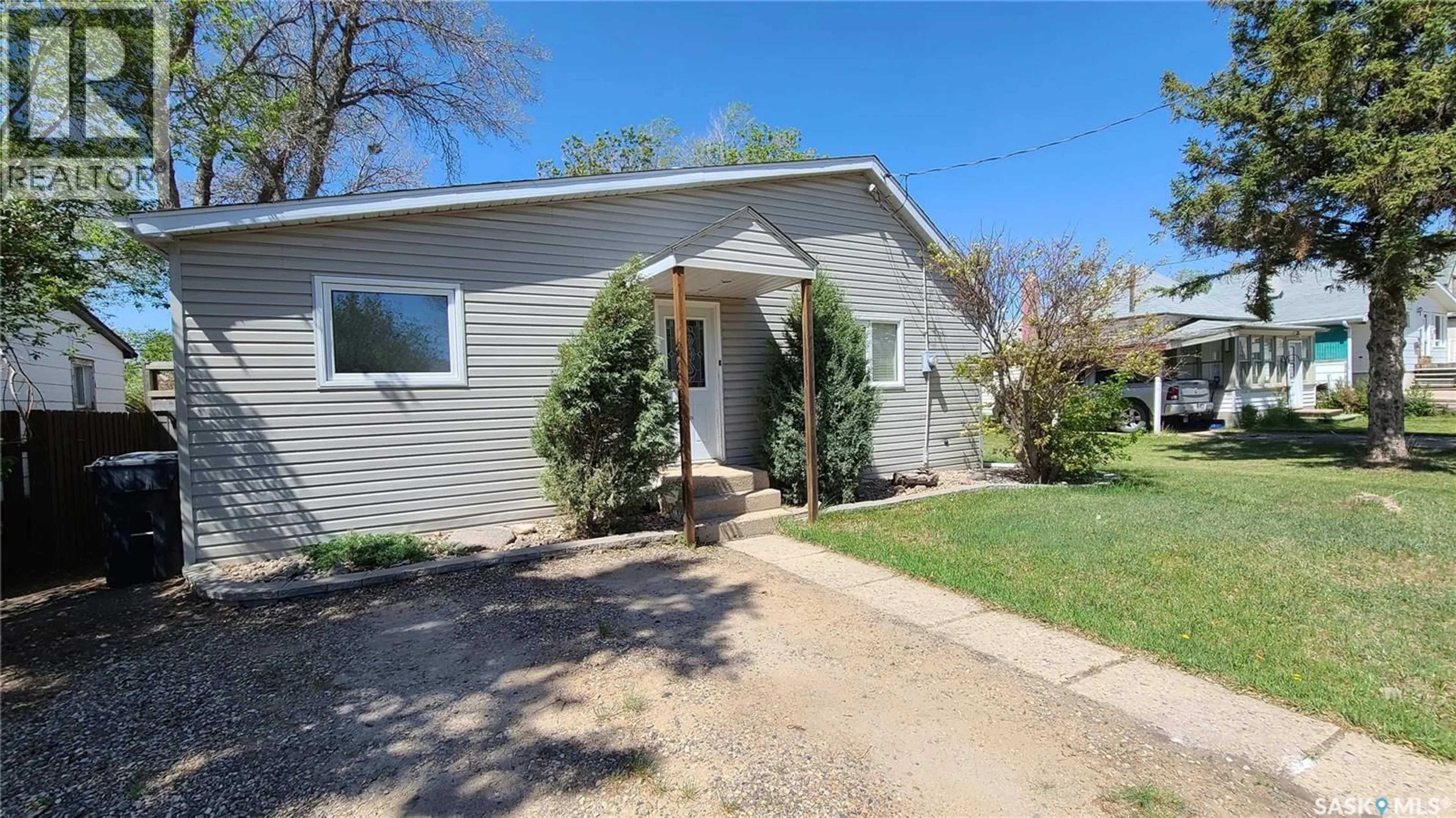 Home with vinyl exterior material, street for 215 MERGENS STREET, Weyburn Saskatchewan S4H1R4