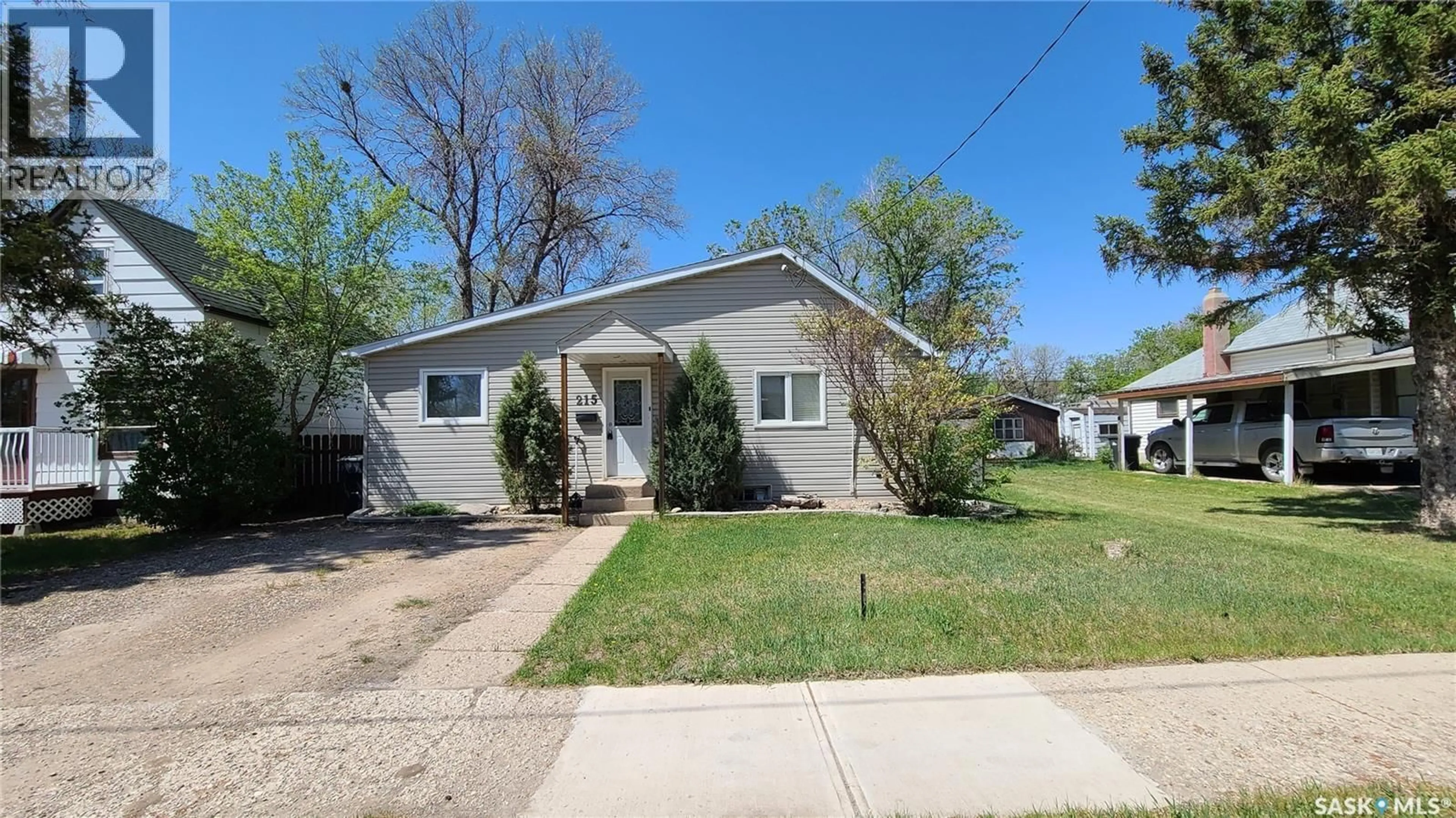 Home with vinyl exterior material, street for 215 MERGENS STREET, Weyburn Saskatchewan S4H1R4