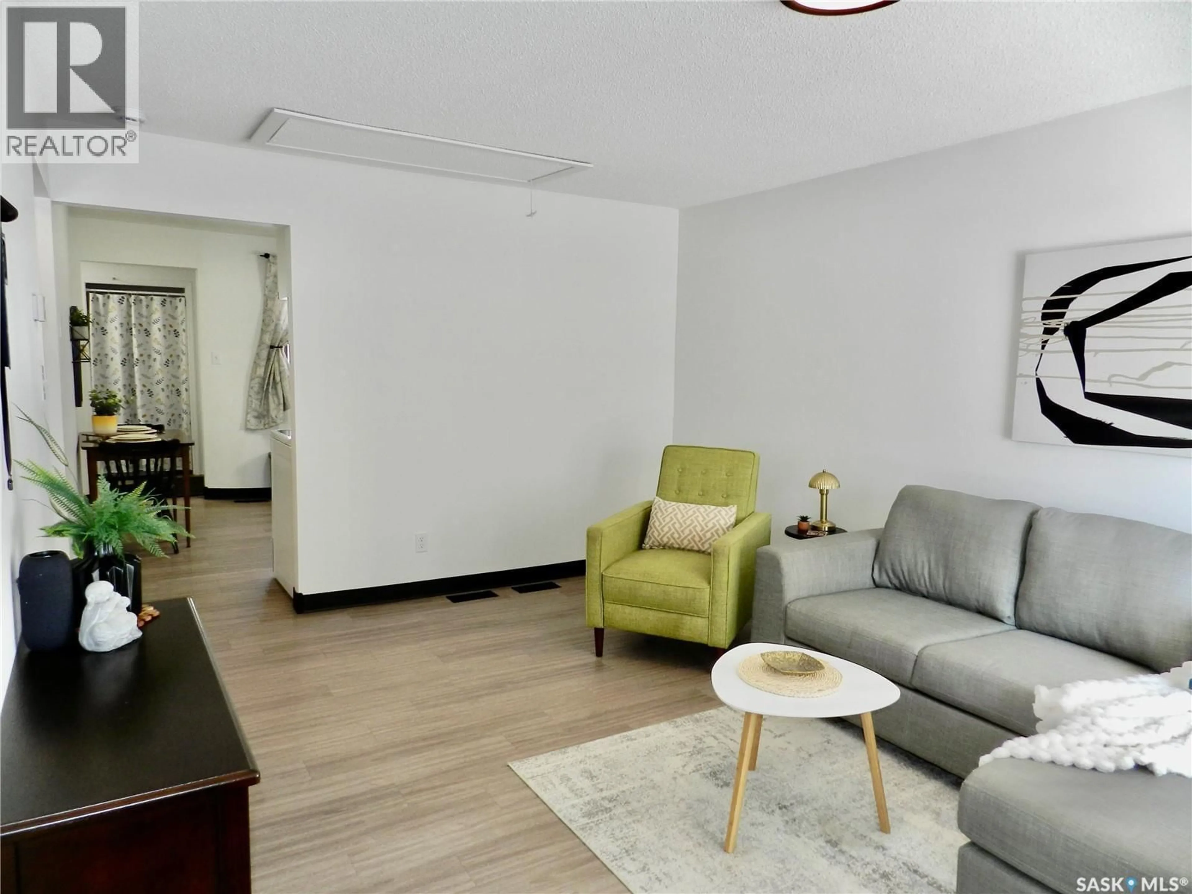 Living room with furniture, wood/laminate floor for 1030 HOCHELAGA STREET, Moose Jaw Saskatchewan S6H2H9