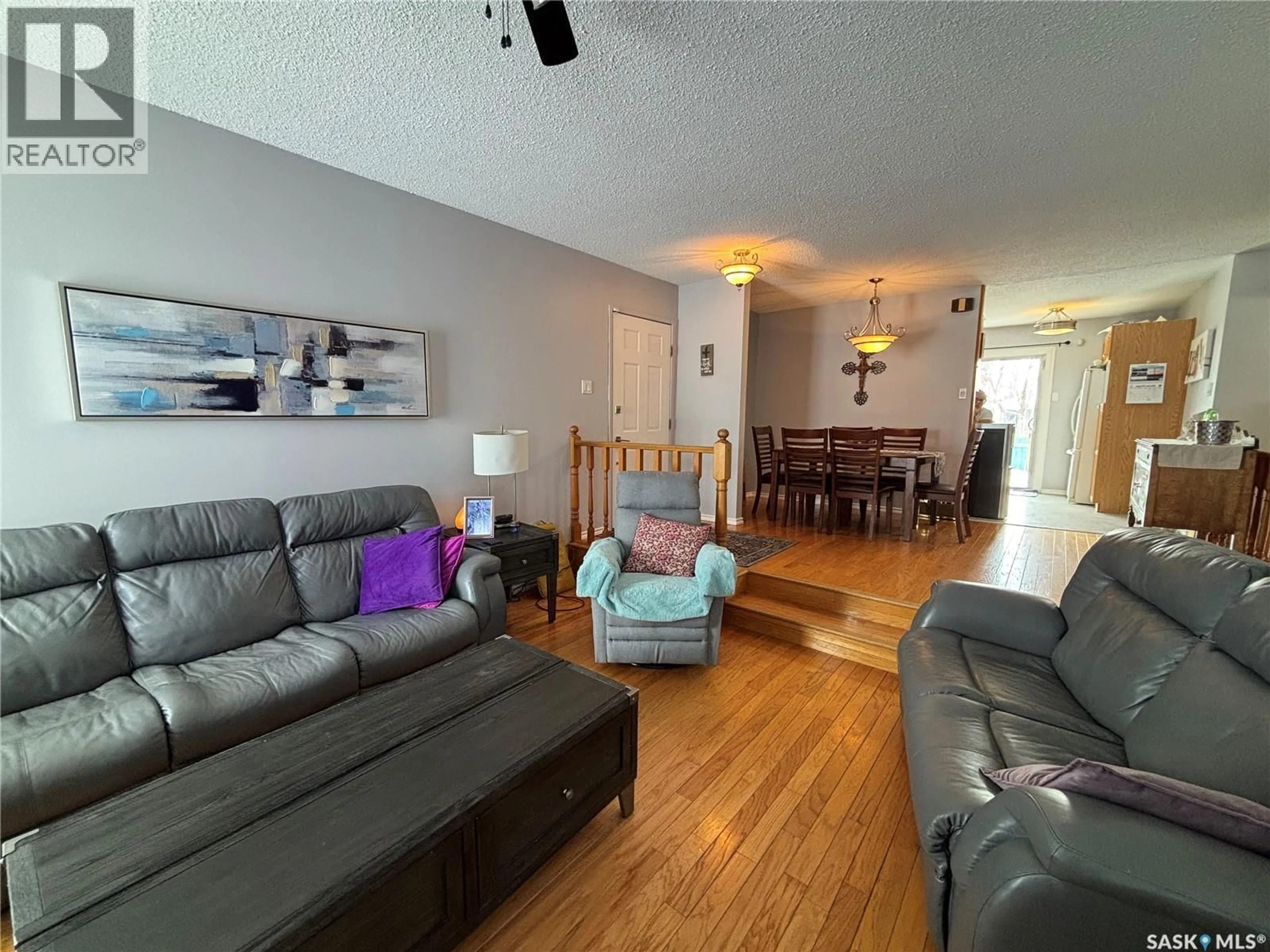 Living room with furniture, wood/laminate floor for 175 ALLANBROOKE DRIVE, Yorkton Saskatchewan S3N3K1