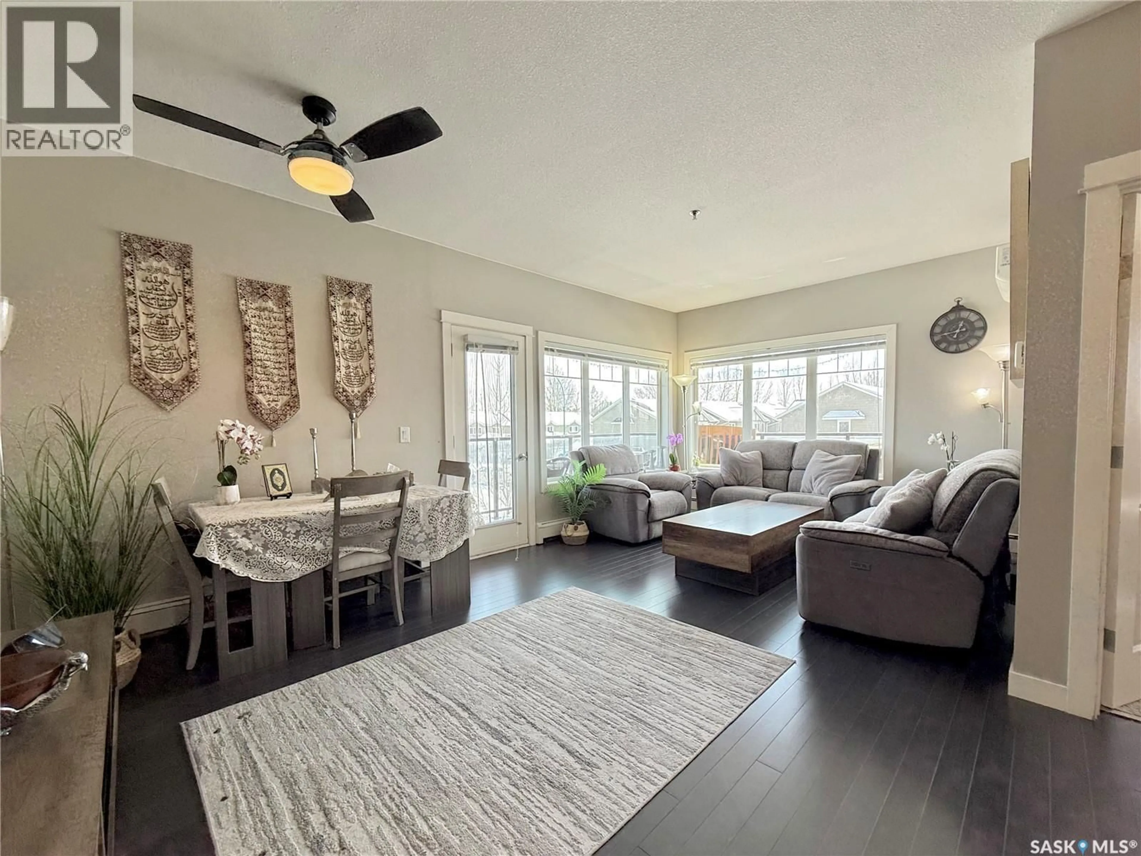 Living room with furniture, wood/laminate floor for 202 HART ROAD, Saskatoon Saskatchewan S7M4P4