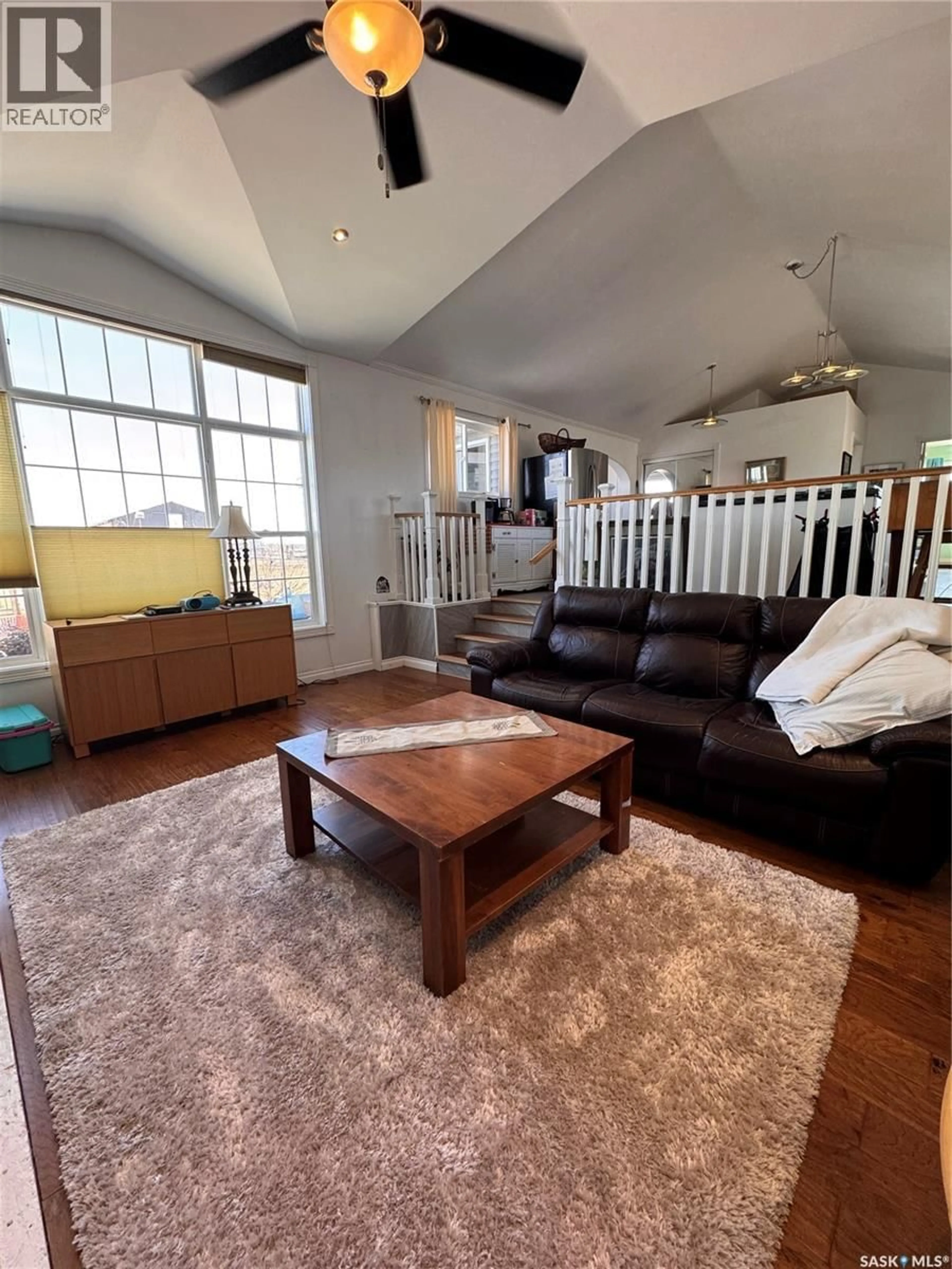 Living room with furniture, wood/laminate floor for McMain - Balgonie COMMUTER ACREAGE, South Qu'Appelle Rm No. 157 Saskatchewan S0G0E0