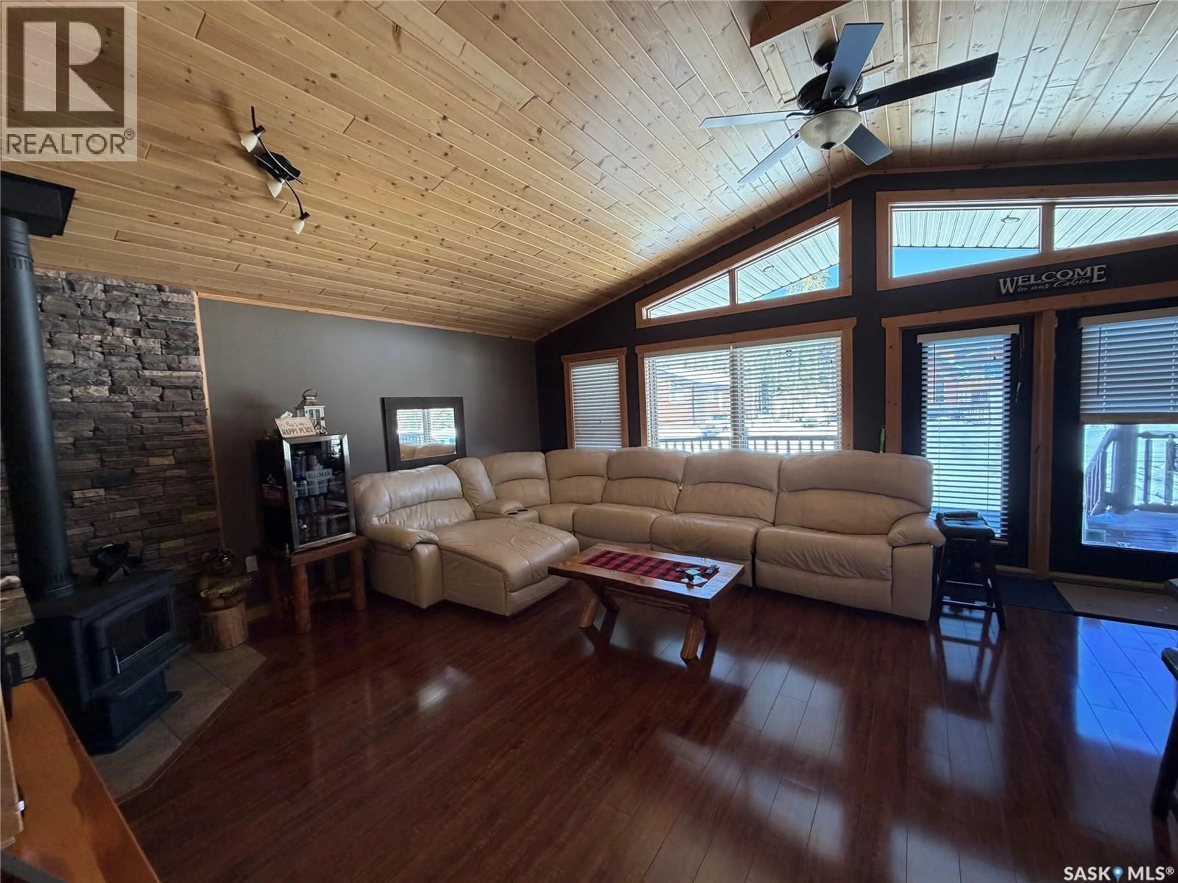 Living room with furniture, wood/laminate floor for 106 SULLIVAN PLACE, Chitek Lake Saskatchewan S0J0L0