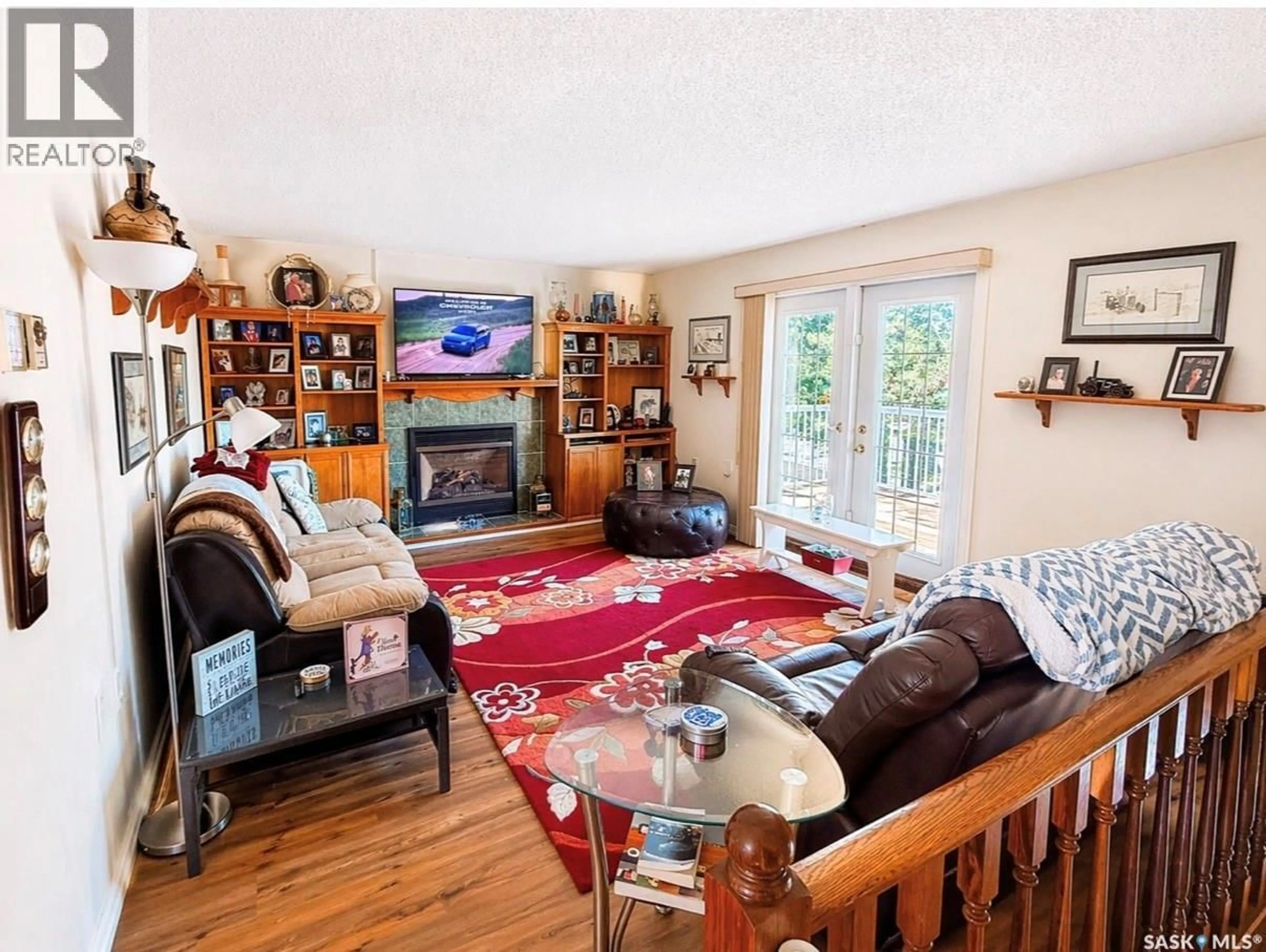 Living room with furniture, wood/laminate floor for 26 SARGENT CRESCENT, Maple Bush Rm No. 224 Saskatchewan S0H3P0