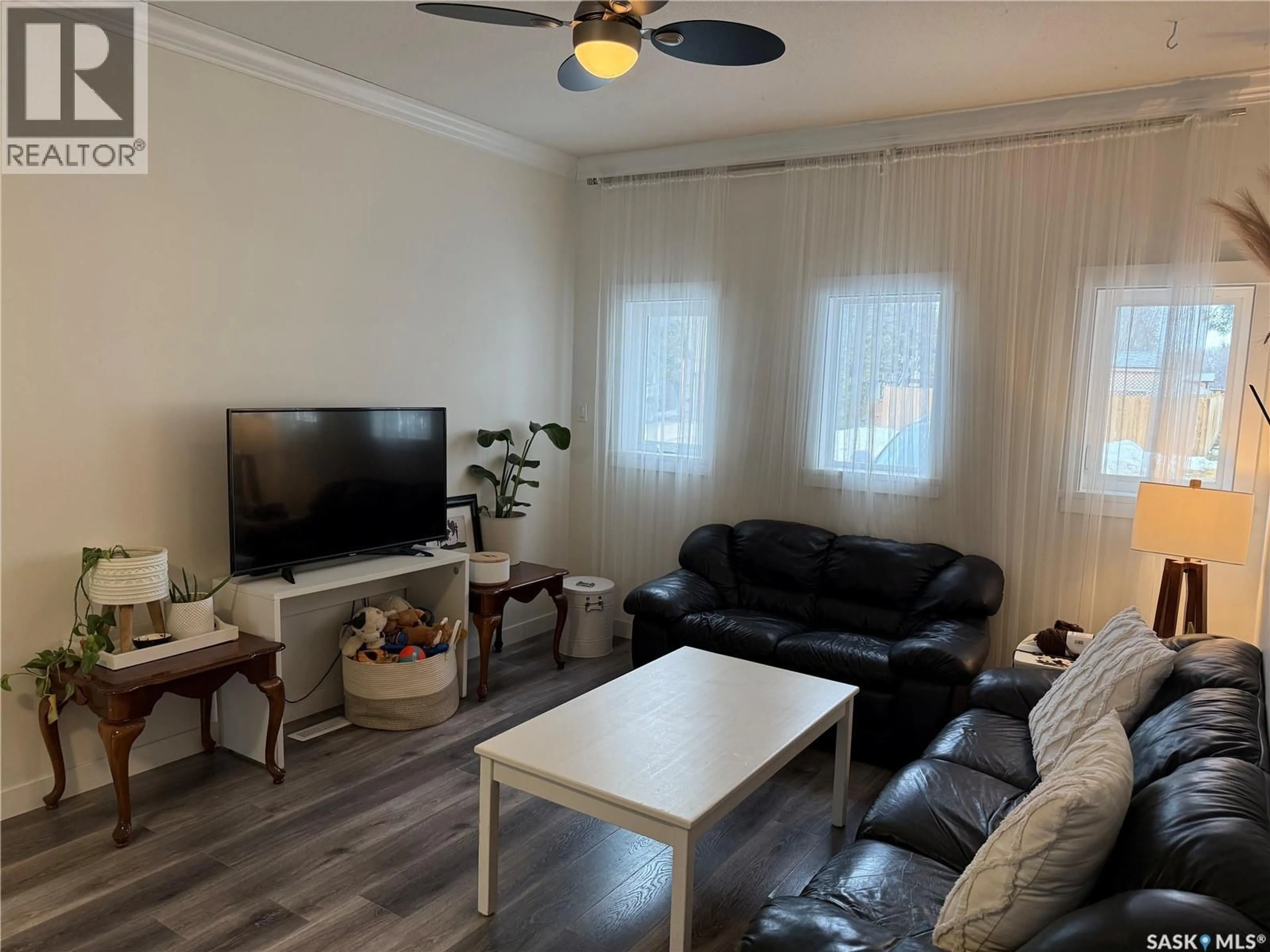 Living room with furniture, wood/laminate floor for 804 6TH STREET, Nipawin Saskatchewan S0E1E0