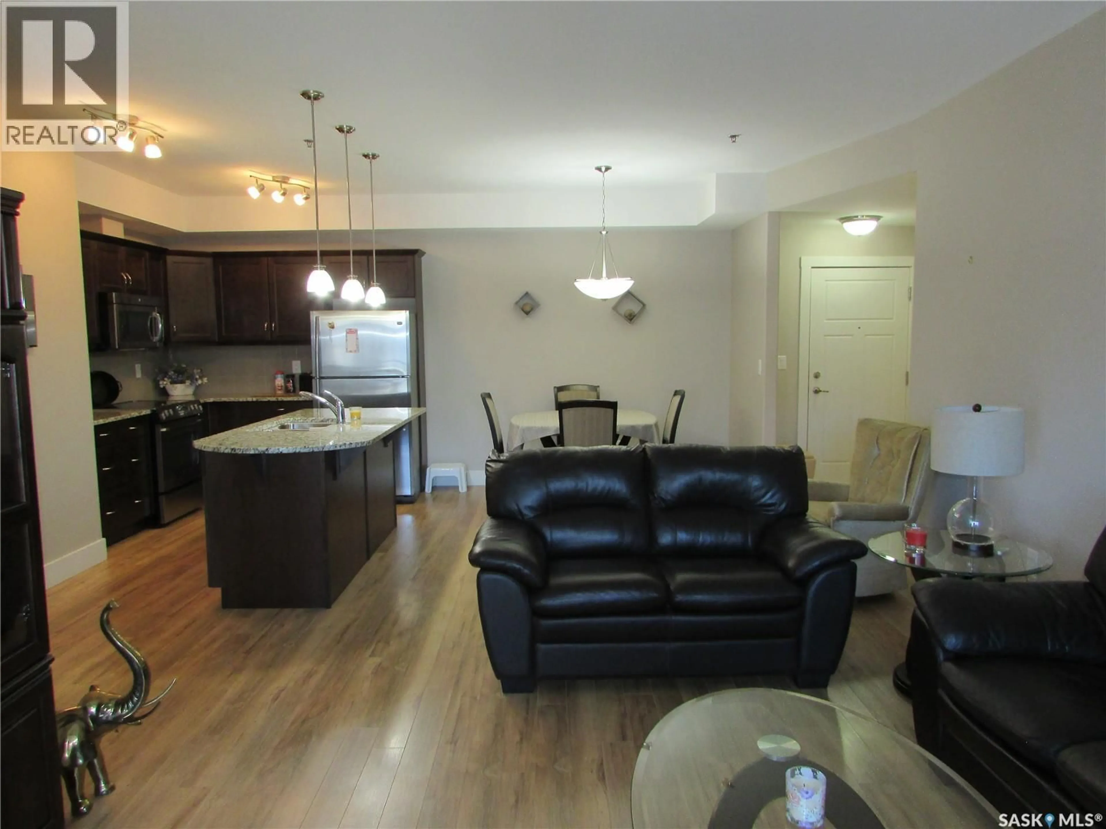 Living room with furniture, wood/laminate floor for 1010 - 222 RUTH STREET, Saskatoon Saskatchewan S7J4M9