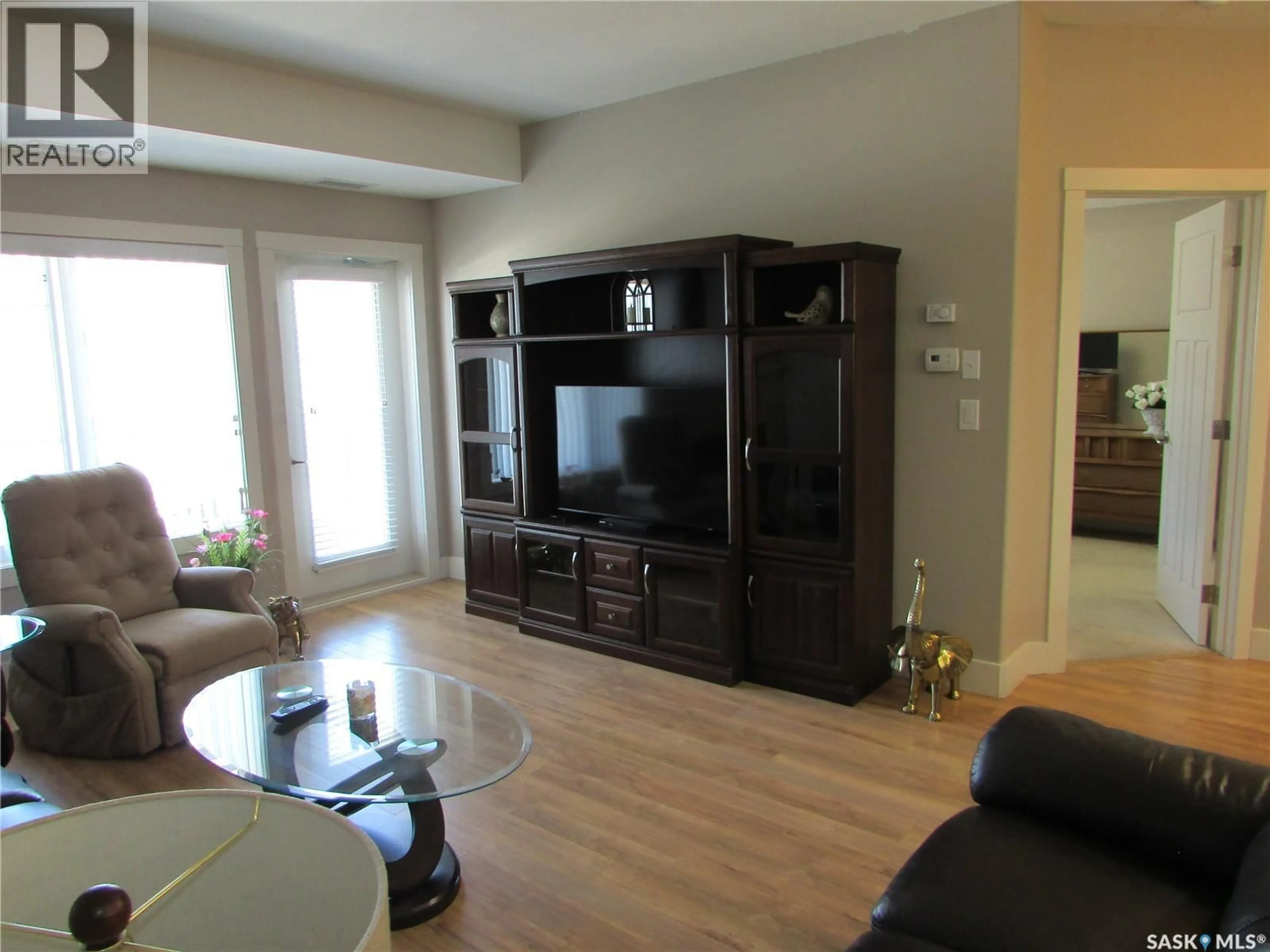 Living room with furniture, wood/laminate floor for 1010 - 222 RUTH STREET, Saskatoon Saskatchewan S7J4M9