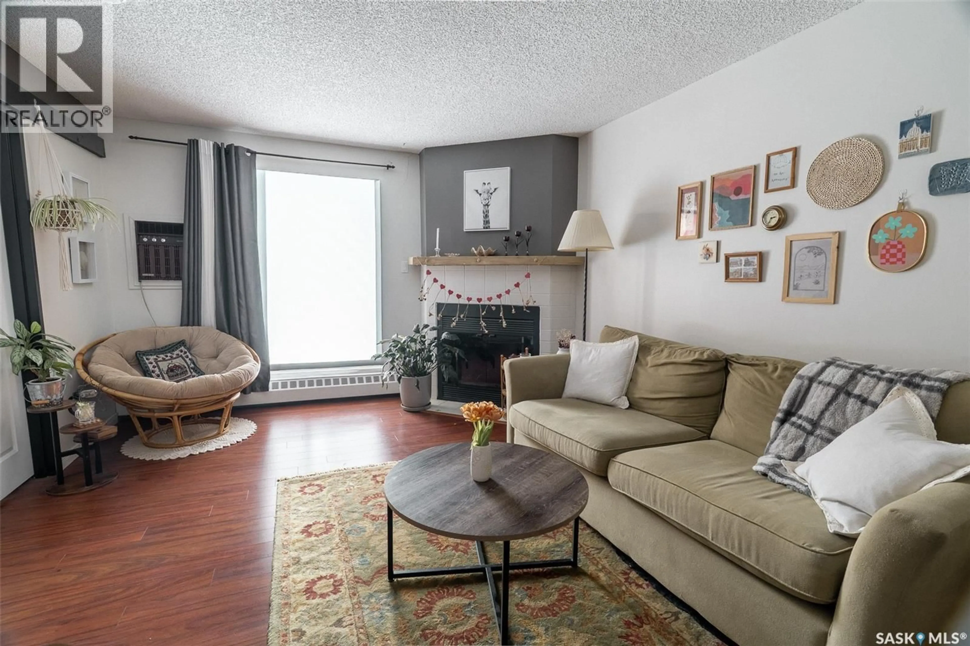 Living room with furniture, wood/laminate floor for 112 - 3420 PARK STREET, Regina Saskatchewan S4V2M9