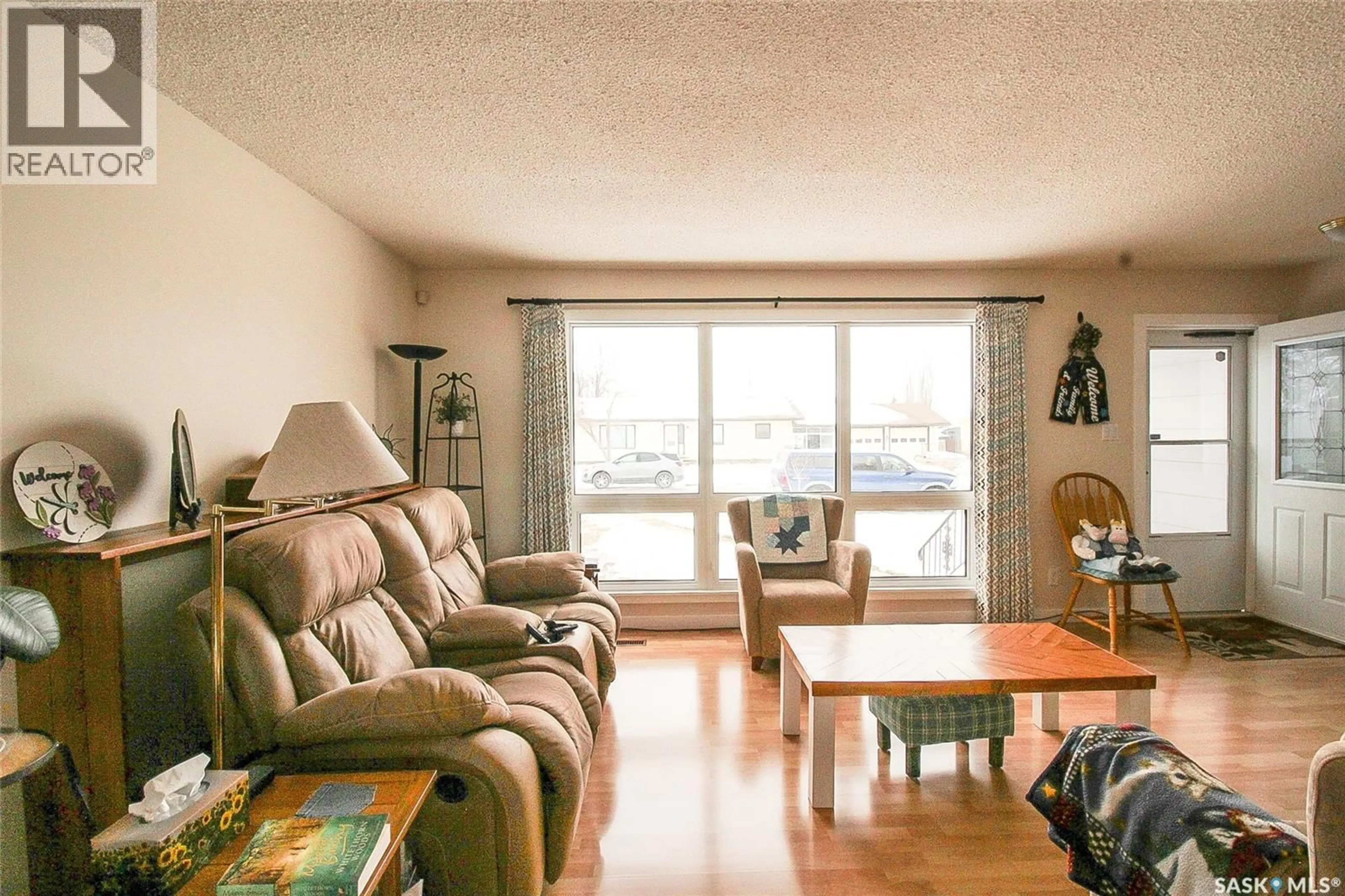 Living room with furniture, wood/laminate floor for 612 9TH STREET, Shaunavon Saskatchewan S0N2M0