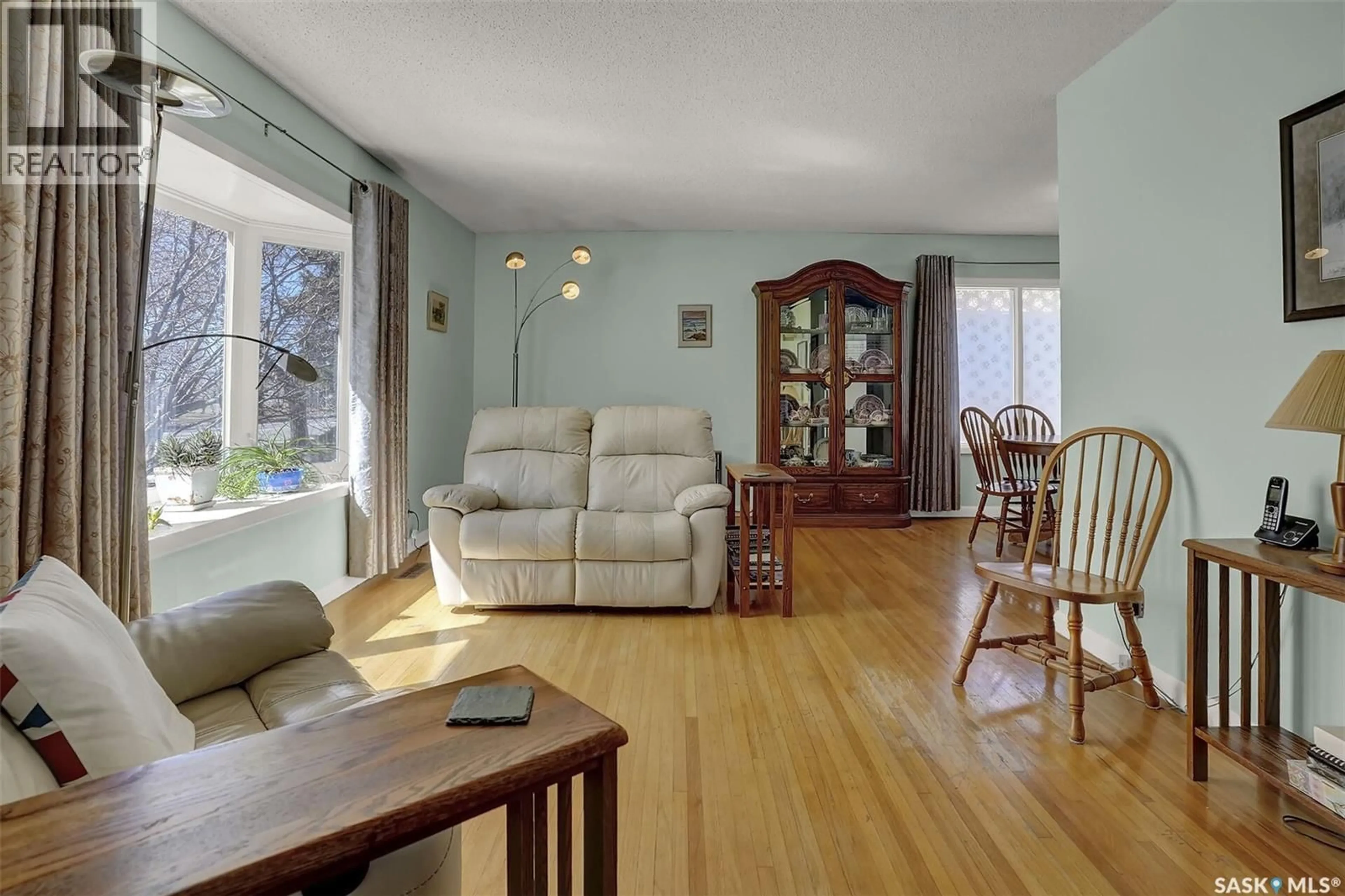 Living room with furniture, wood/laminate floor for 4220 REGINA AVENUE, Regina Saskatchewan S4S0J4