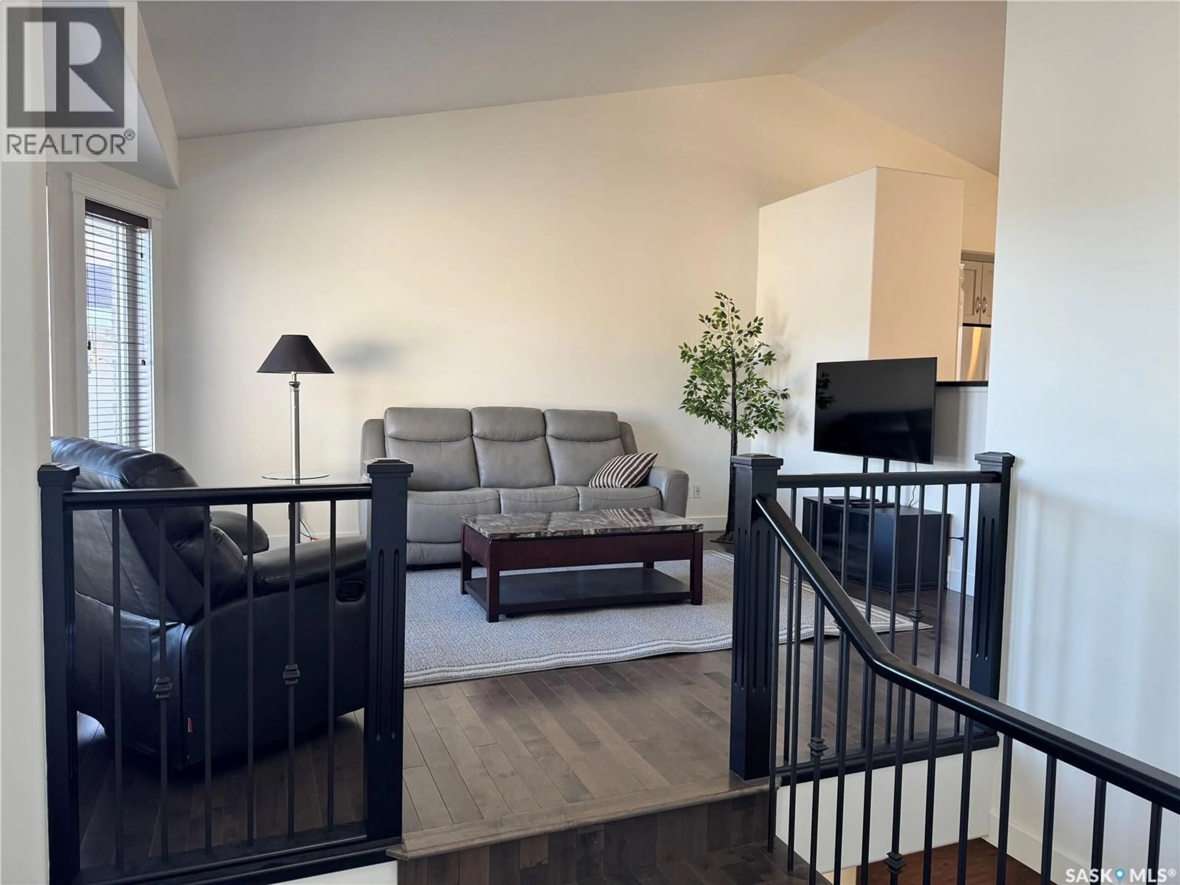 Living room with furniture, wood/laminate floor for 1118 PATON LANE, Saskatoon Saskatchewan S7W0C1