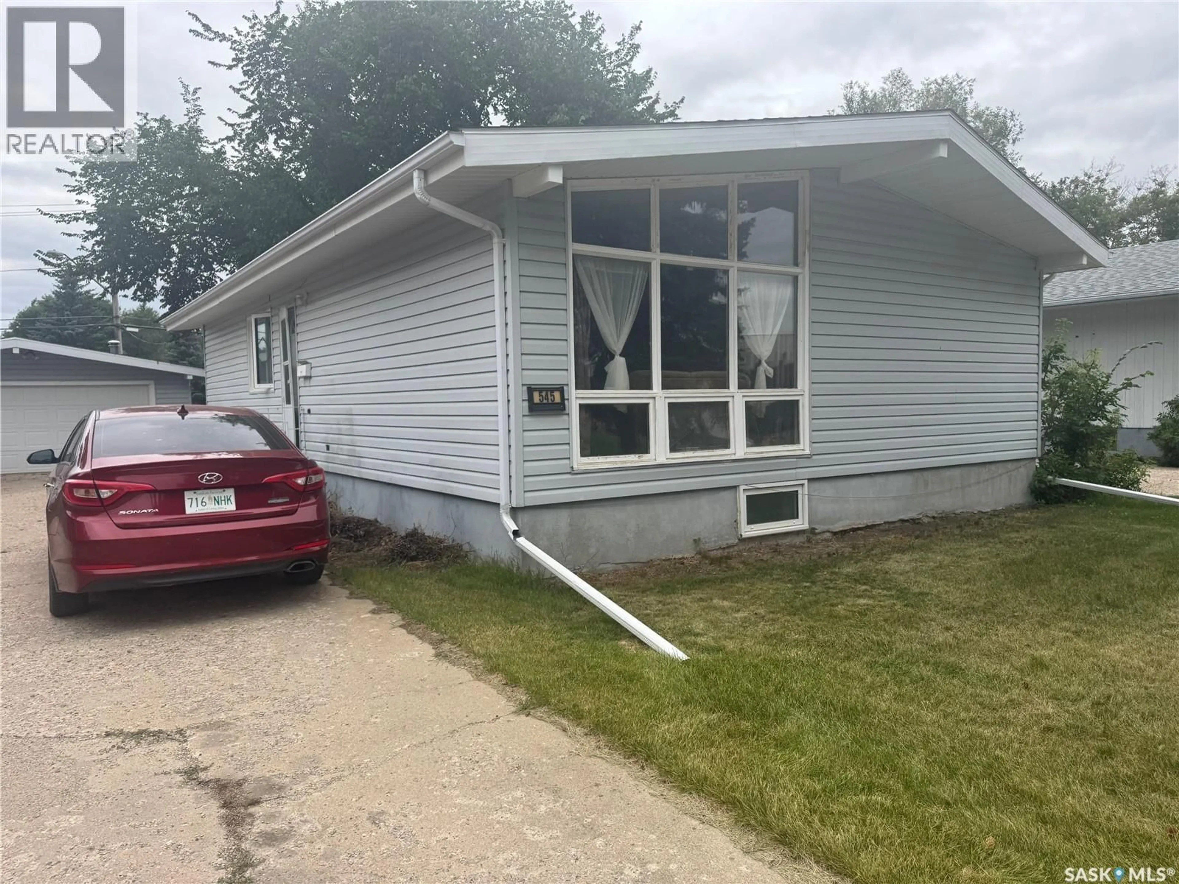 Home with vinyl exterior material, street for 545 5TH STREET, Weyburn Saskatchewan S4H0Z9