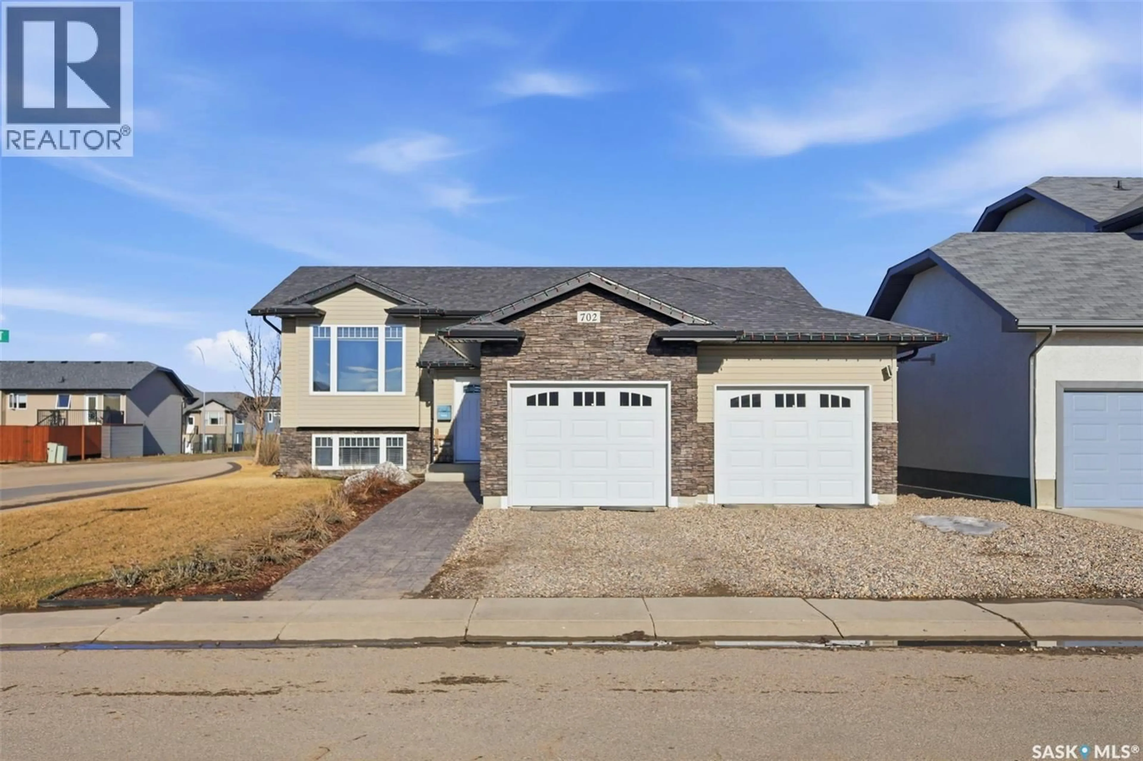 Home with brick exterior material, street for 702 JANESON COURT, Warman Saskatchewan S0K4S2
