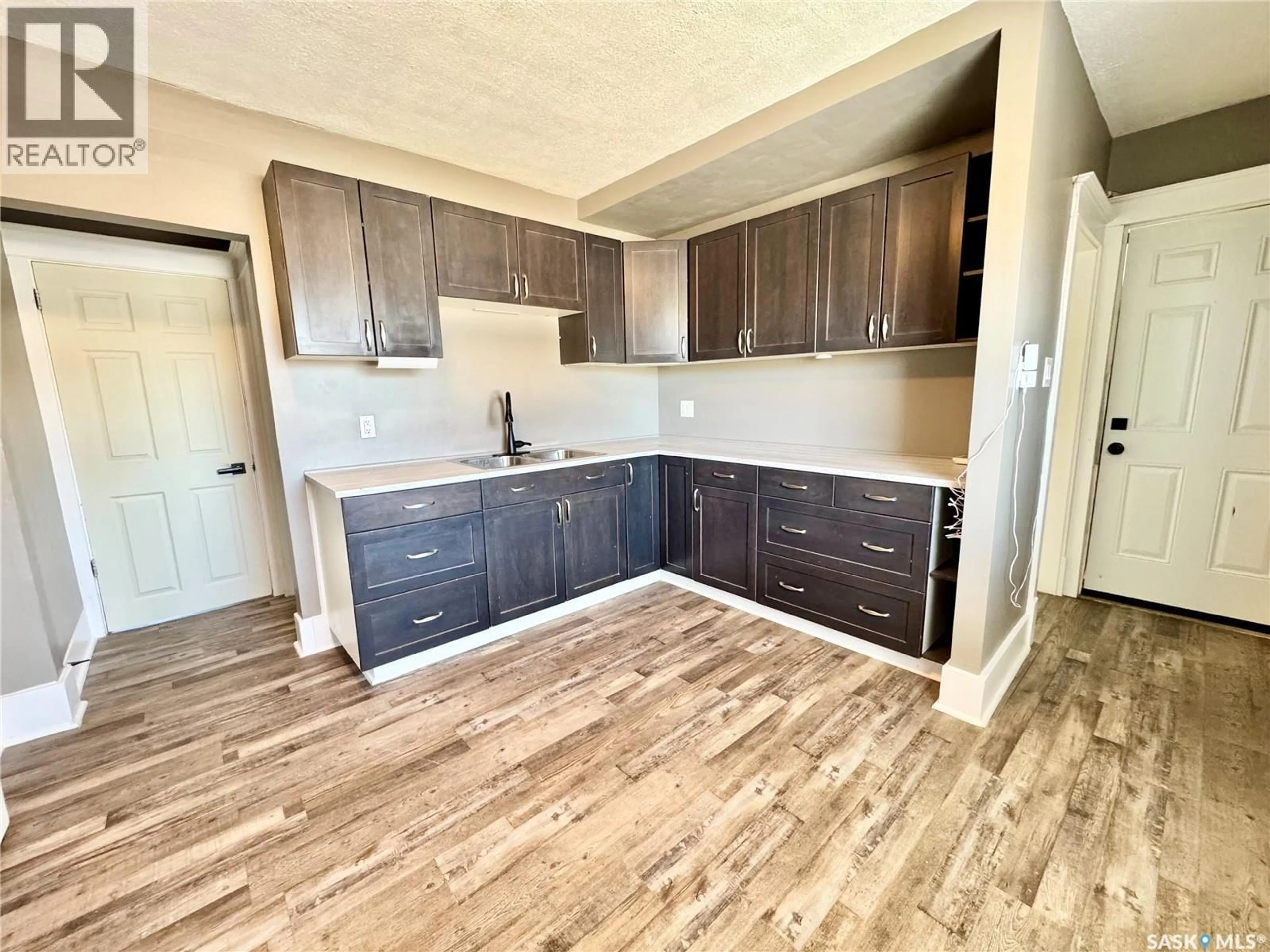 Open concept kitchen, wood/laminate floor for 1467 15TH STREET, Prince Albert Saskatchewan S6V3S9
