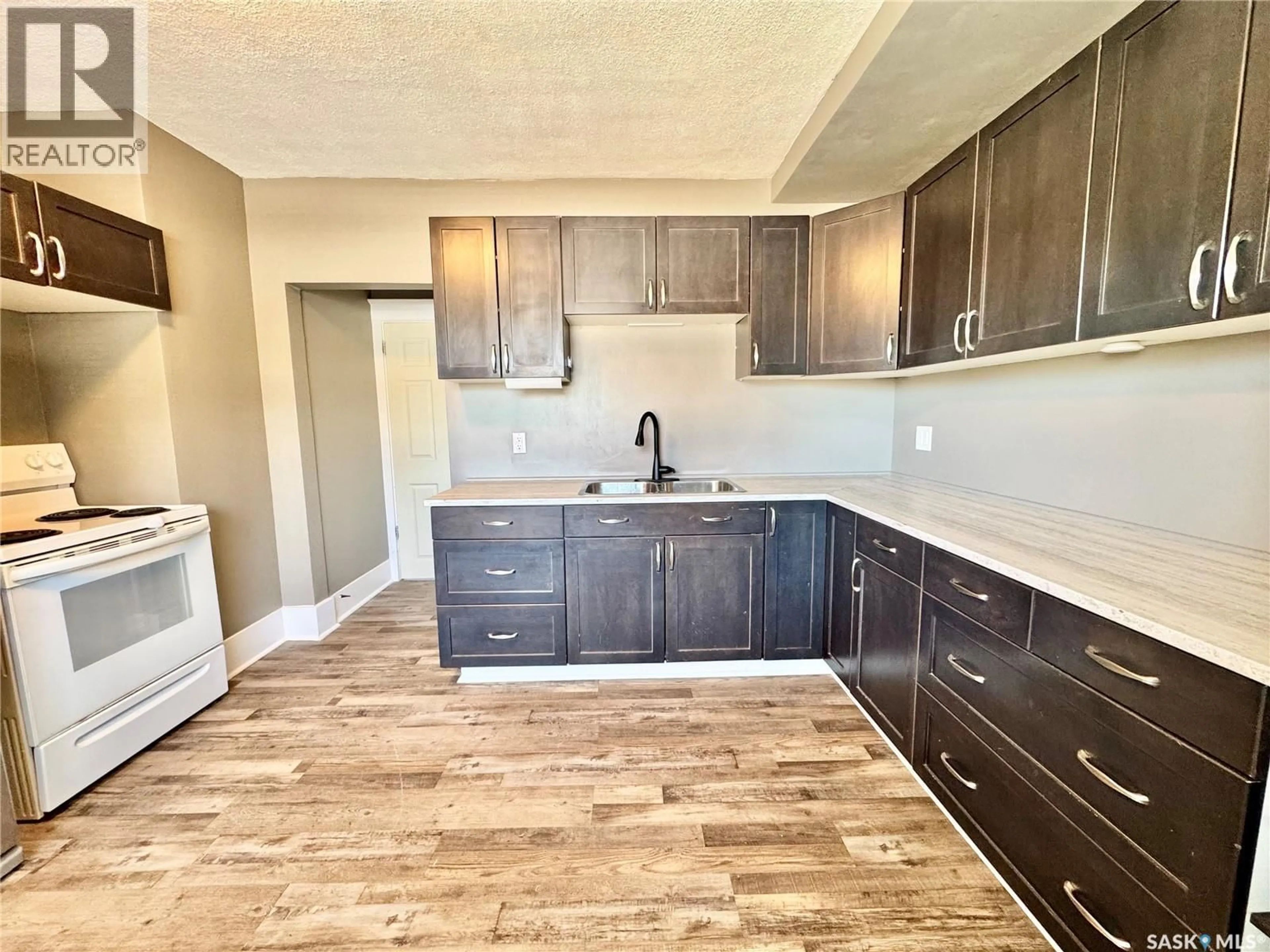 Open concept kitchen, wood/laminate floor for 1467 15TH STREET, Prince Albert Saskatchewan S6V3S9