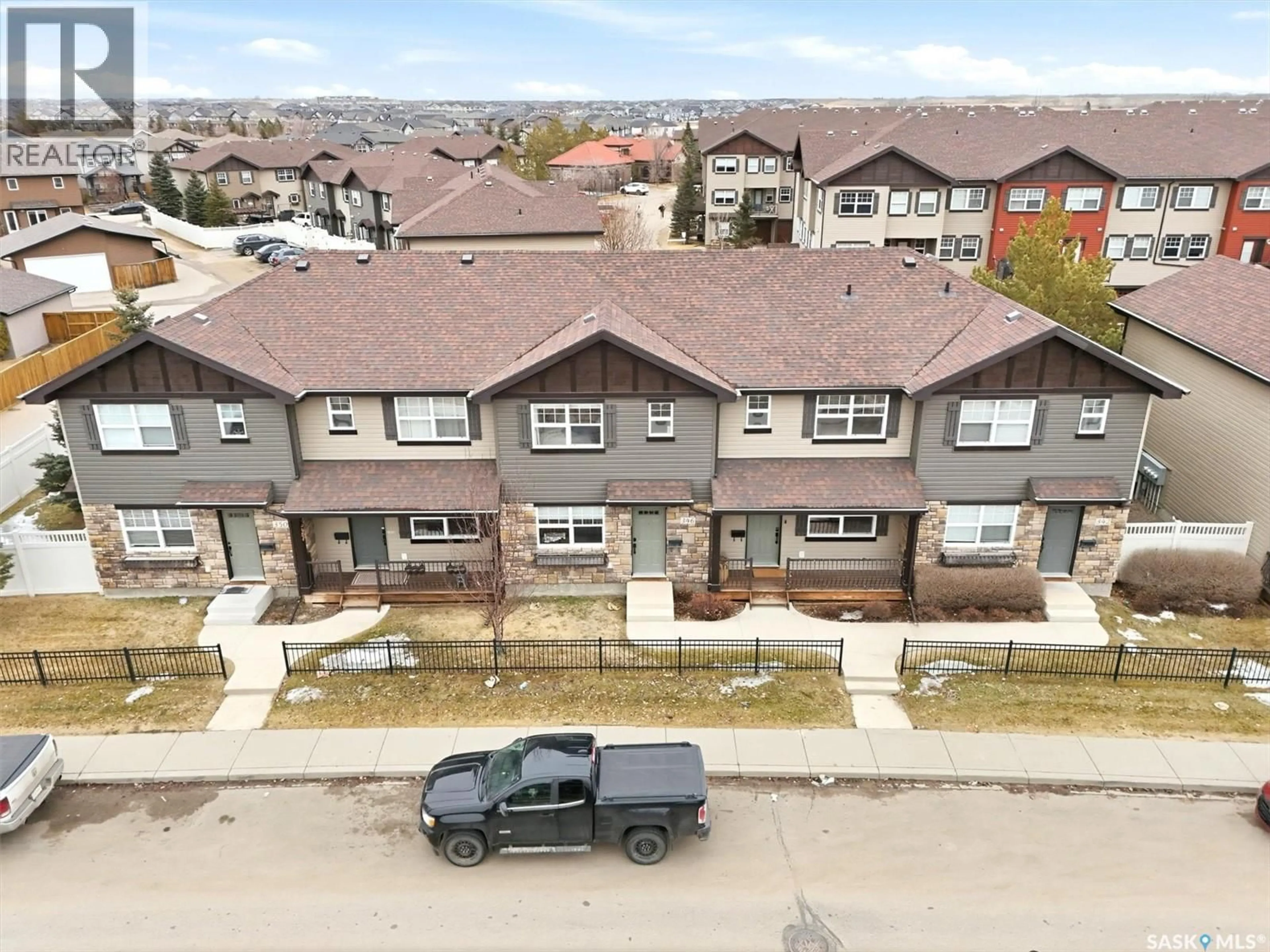 A pic from outside/outdoor area/front of a property/back of a property/a pic from drone, street for 344 LEVALLEY COVE, Saskatoon Saskatchewan S7T0L1