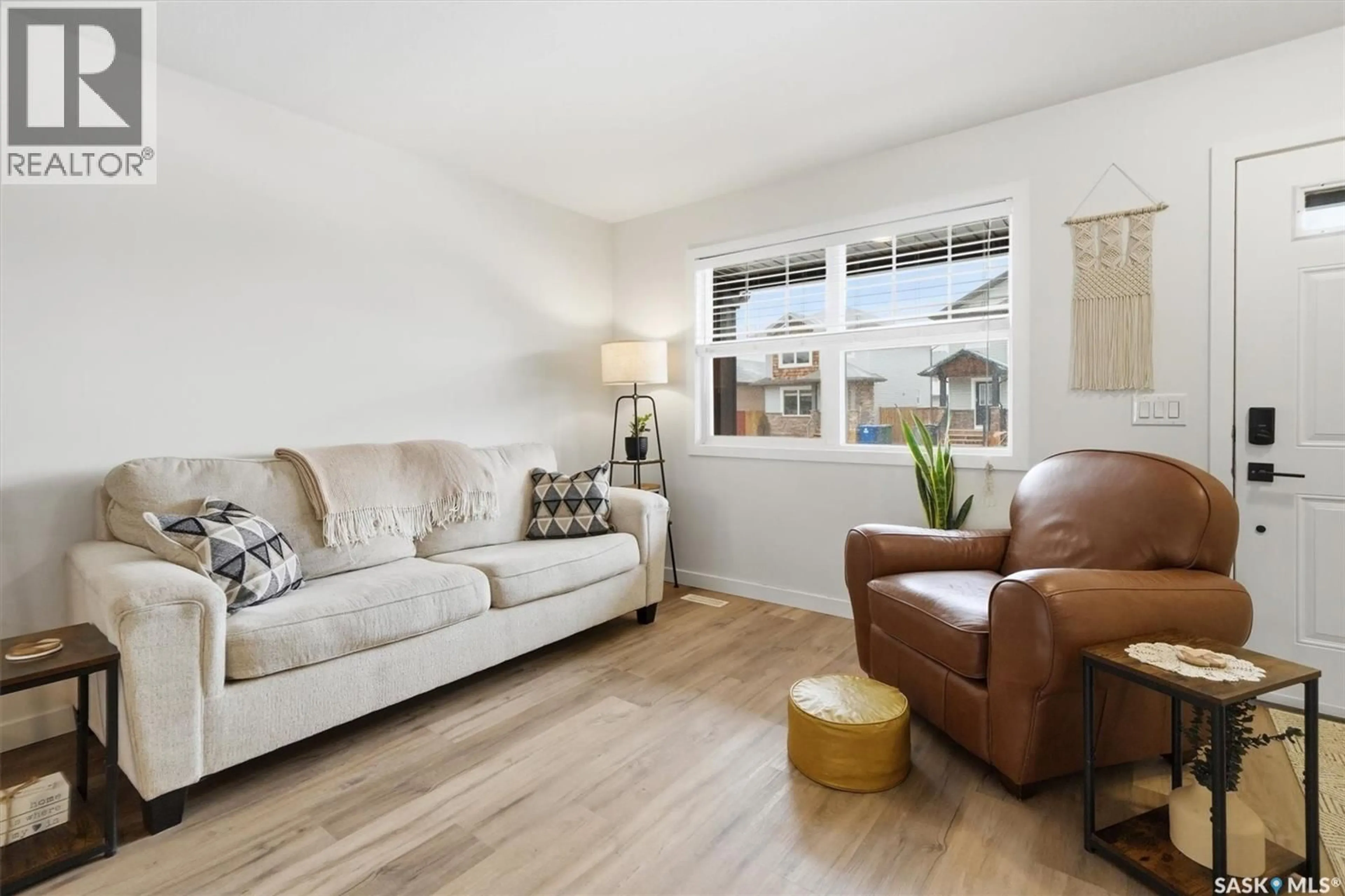 Living room with furniture, wood/laminate floor for 344 LEVALLEY COVE, Saskatoon Saskatchewan S7T0L1