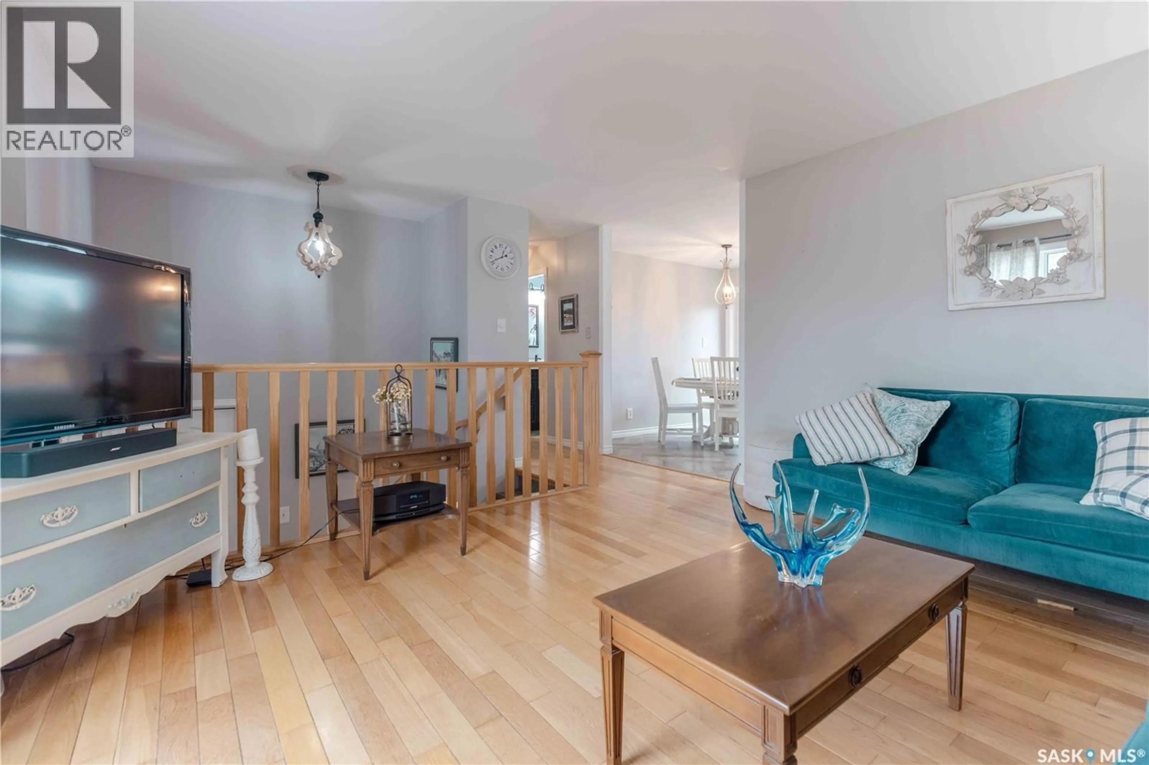 Living room with furniture, wood/laminate floor for 538 NESBITT LANE, Saskatoon Saskatchewan S7L6K9