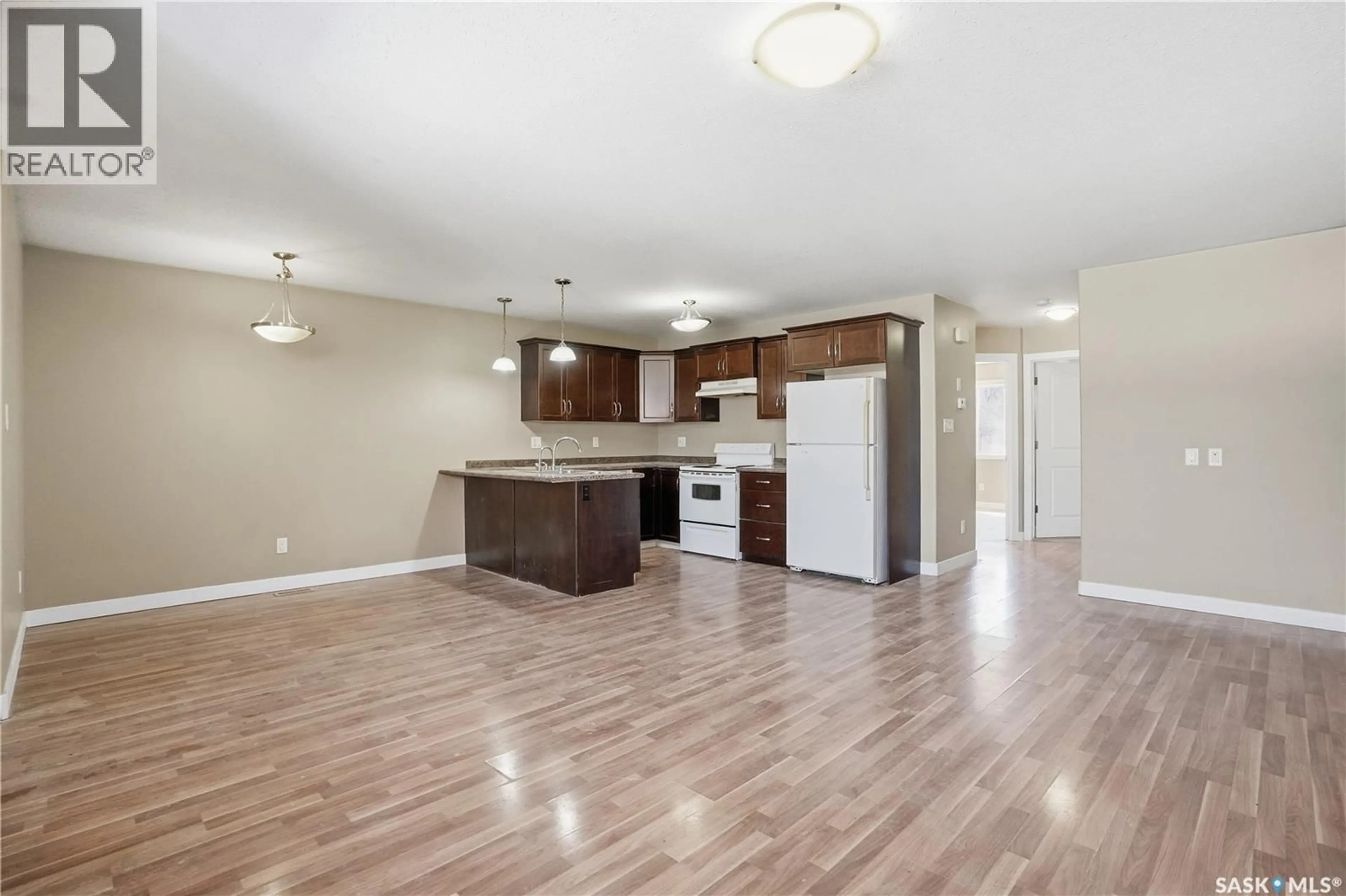 Open concept kitchen, wood/laminate floor for 1152 CAMERON STREET, Regina Saskatchewan S4T2S8