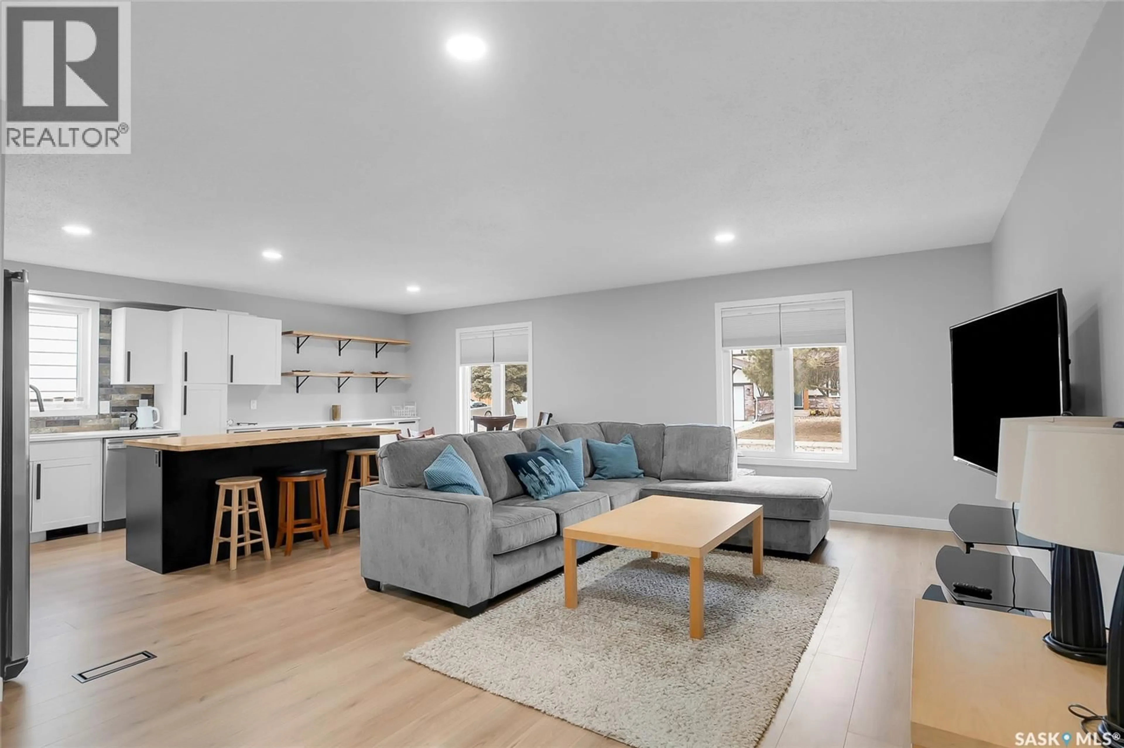 Living room with furniture, wood/laminate floor for 62 ROBORECKI TERRACE, Saskatoon Saskatchewan S7K5L3