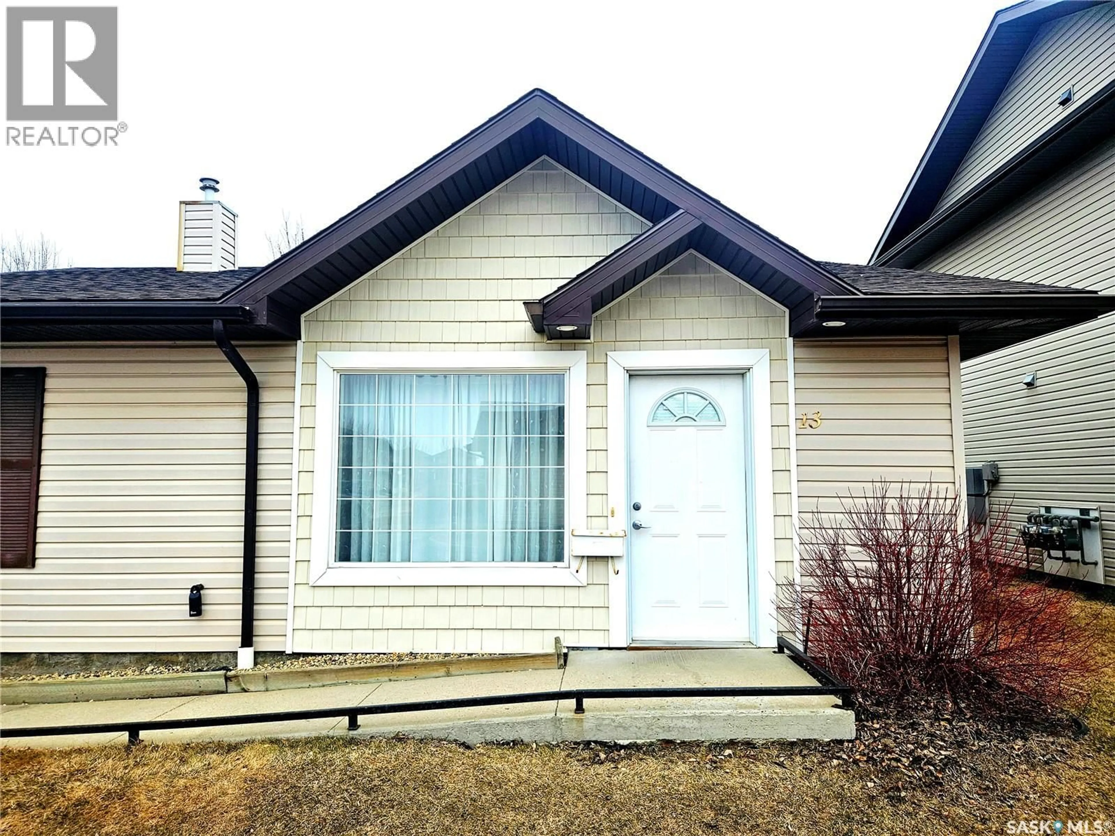 Home with vinyl exterior material, street for 13 135 KEEDWELL STREET, Saskatoon Saskatchewan S7W0A3