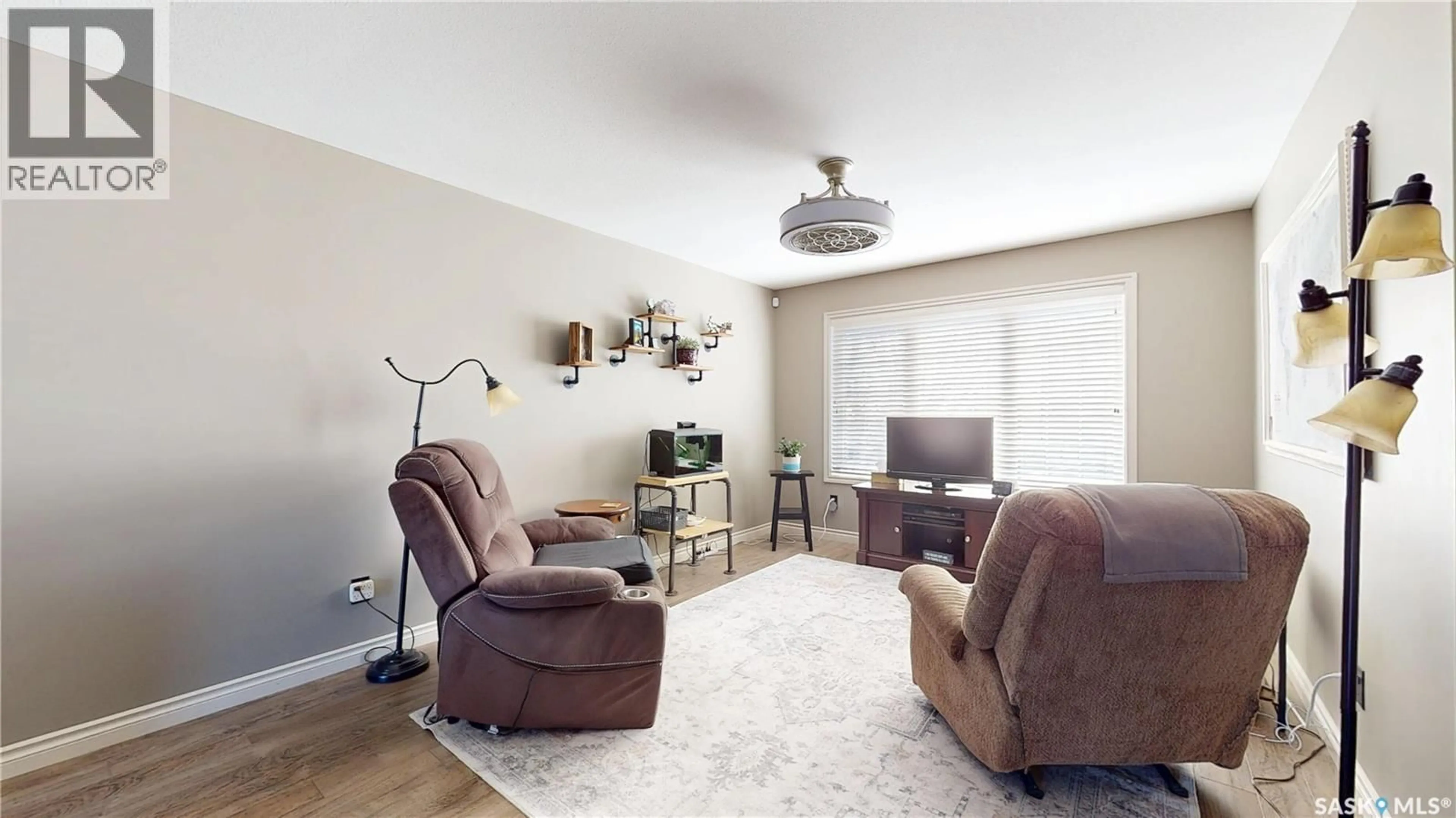 Living room with furniture, wood/laminate floor for 5454 MITCHINSON WAY, Regina Saskatchewan S4W0E7