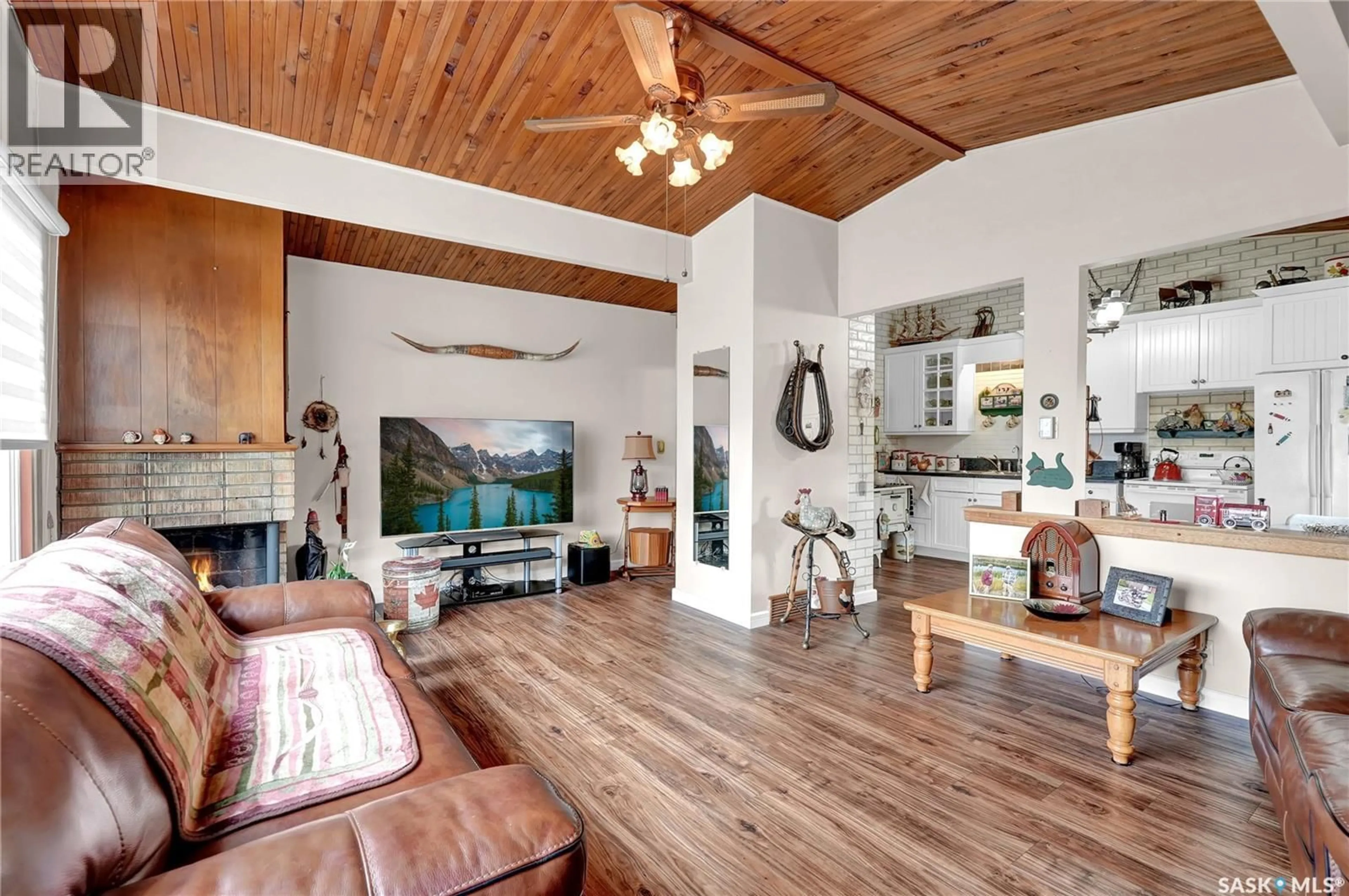 Living room with furniture, wood/laminate floor for 3435 WASCANA STREET, Regina Saskatchewan S4S2H2