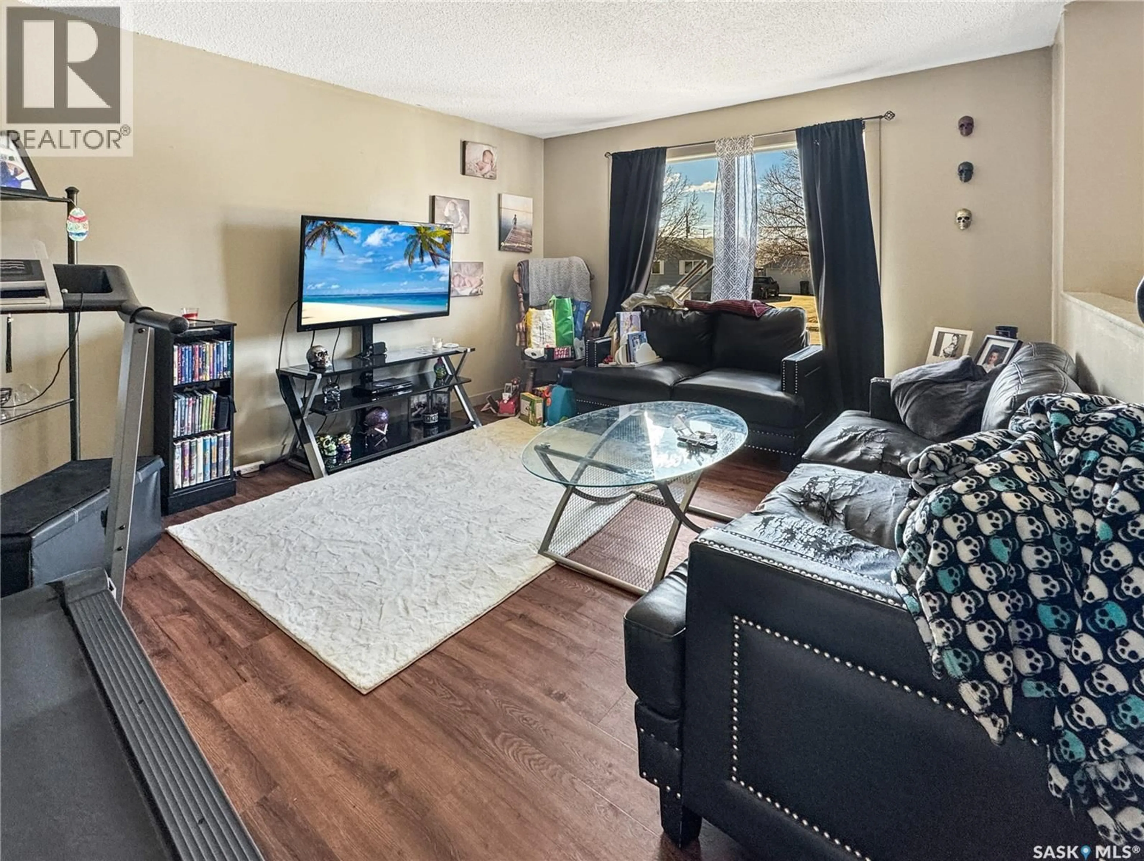 Living room with furniture, wood/laminate floor for 1442 111TH STREET, North Battleford Saskatchewan S9A2K6