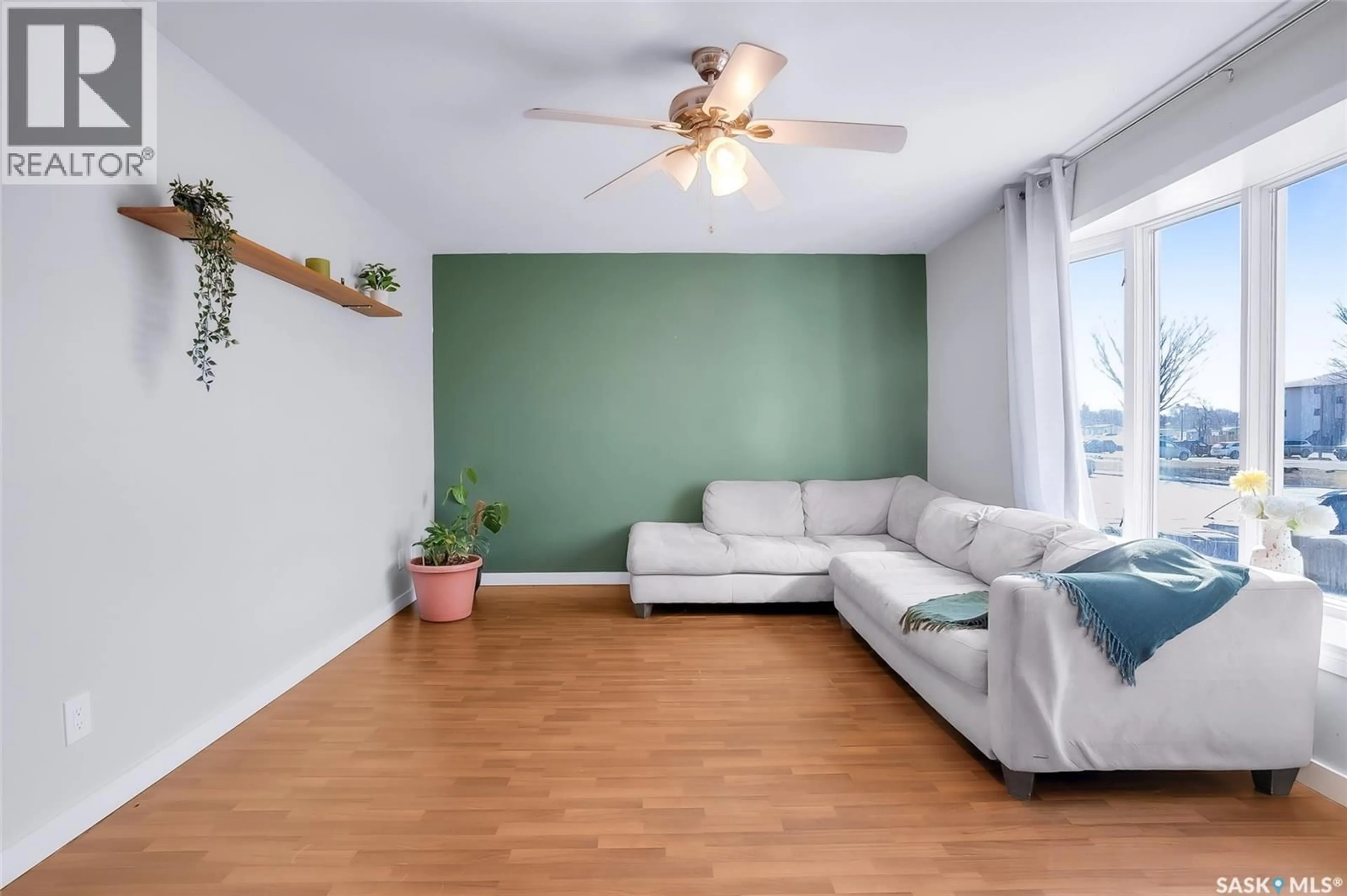 Living room with furniture, wood/laminate floor for 122 CLANCY DRIVE, Saskatoon Saskatchewan S7M4L2