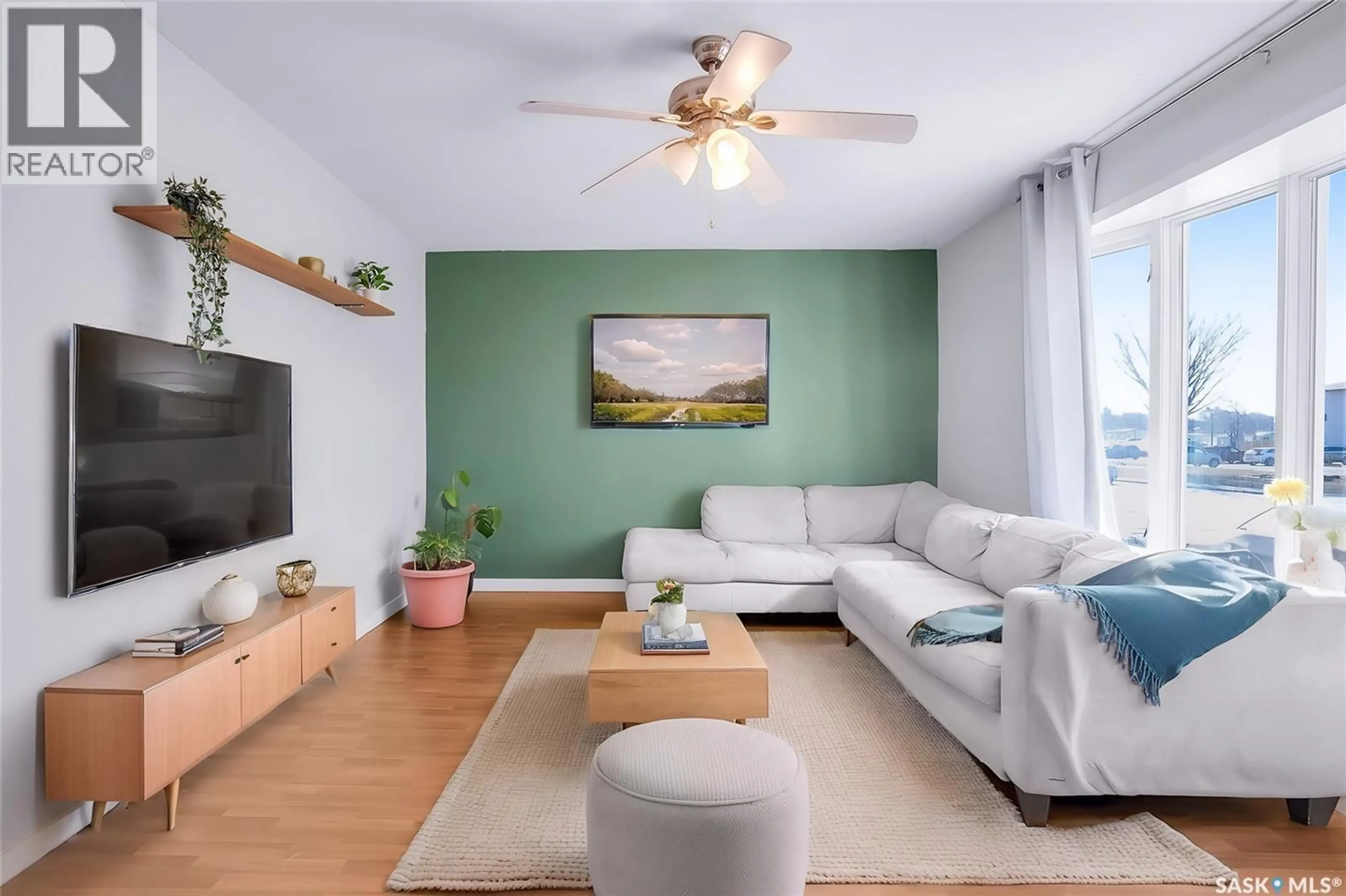 Living room with furniture, wood/laminate floor for 122 CLANCY DRIVE, Saskatoon Saskatchewan S7M4L2