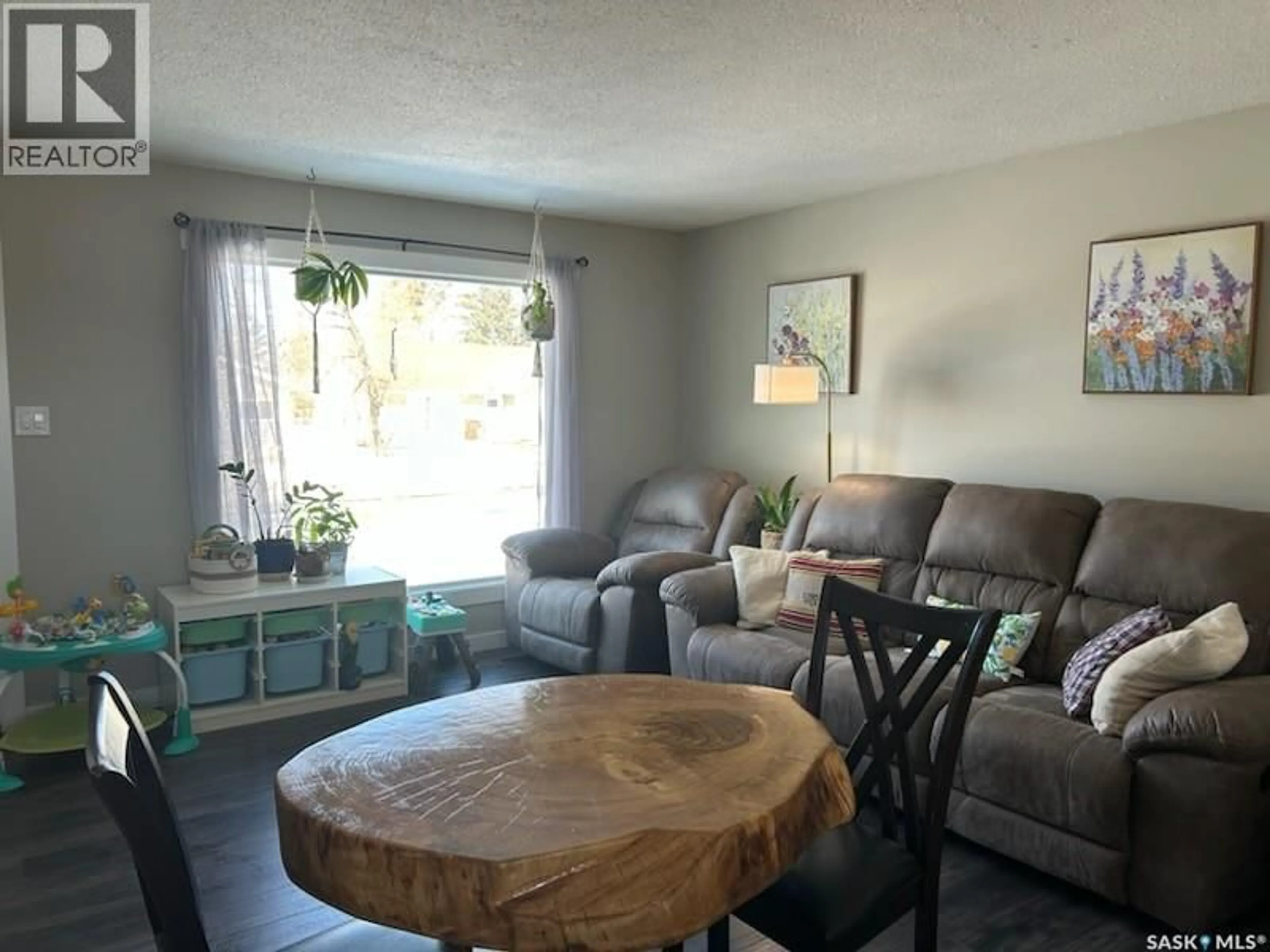 Living room with furniture, wood/laminate floor for 602 97TH AVENUE, Tisdale Saskatchewan S0E1T0