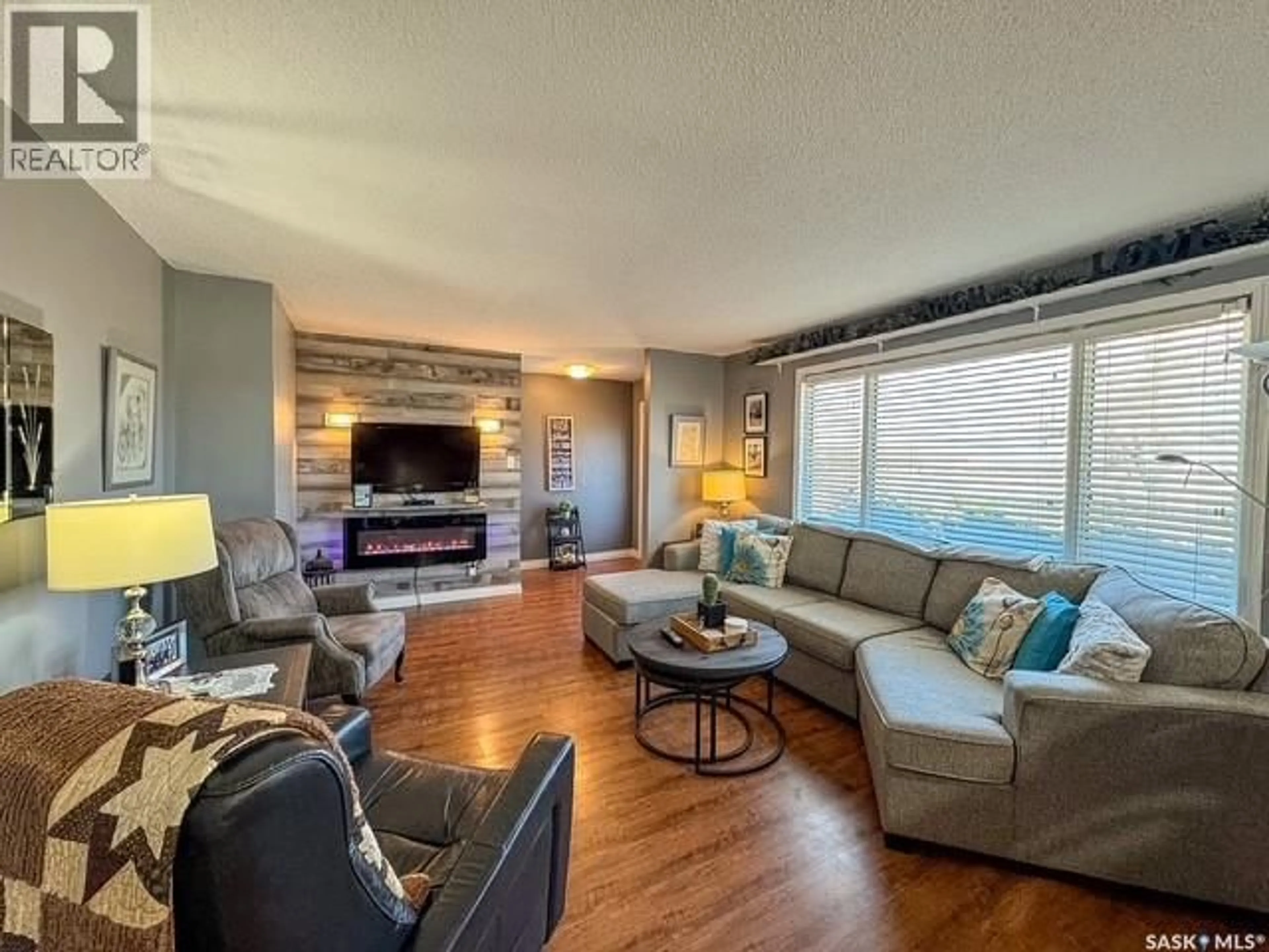 Living room with furniture, wood/laminate floor for 113 1ST STREET, Swift Current Rm No. 137 Saskatchewan S9H4V1
