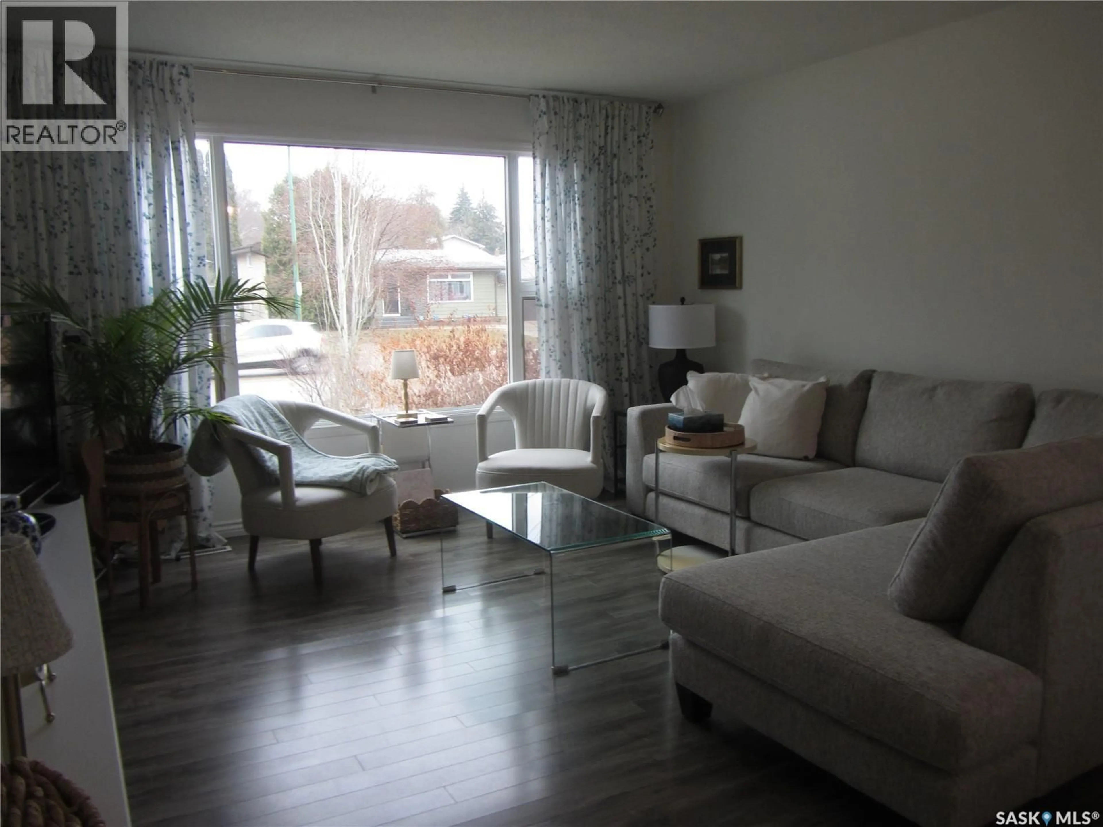 Living room with furniture, wood/laminate floor for 1802 ARLINGTON AVENUE, Saskatoon Saskatchewan S7H2Y7