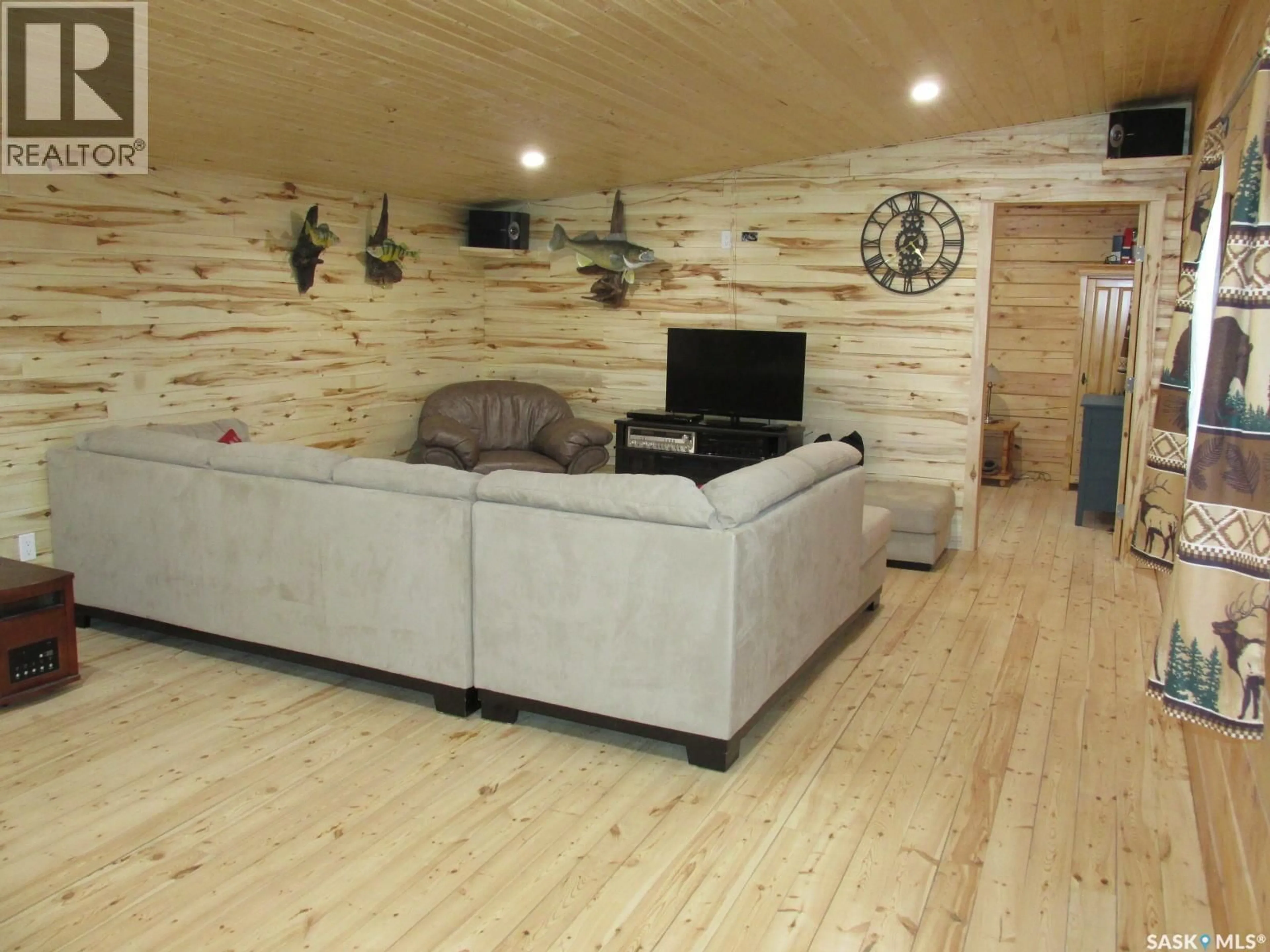 Living room with furniture, wood/laminate floor for 109 RUSTAD AVENUE, White Fox Saskatchewan S0J3B0