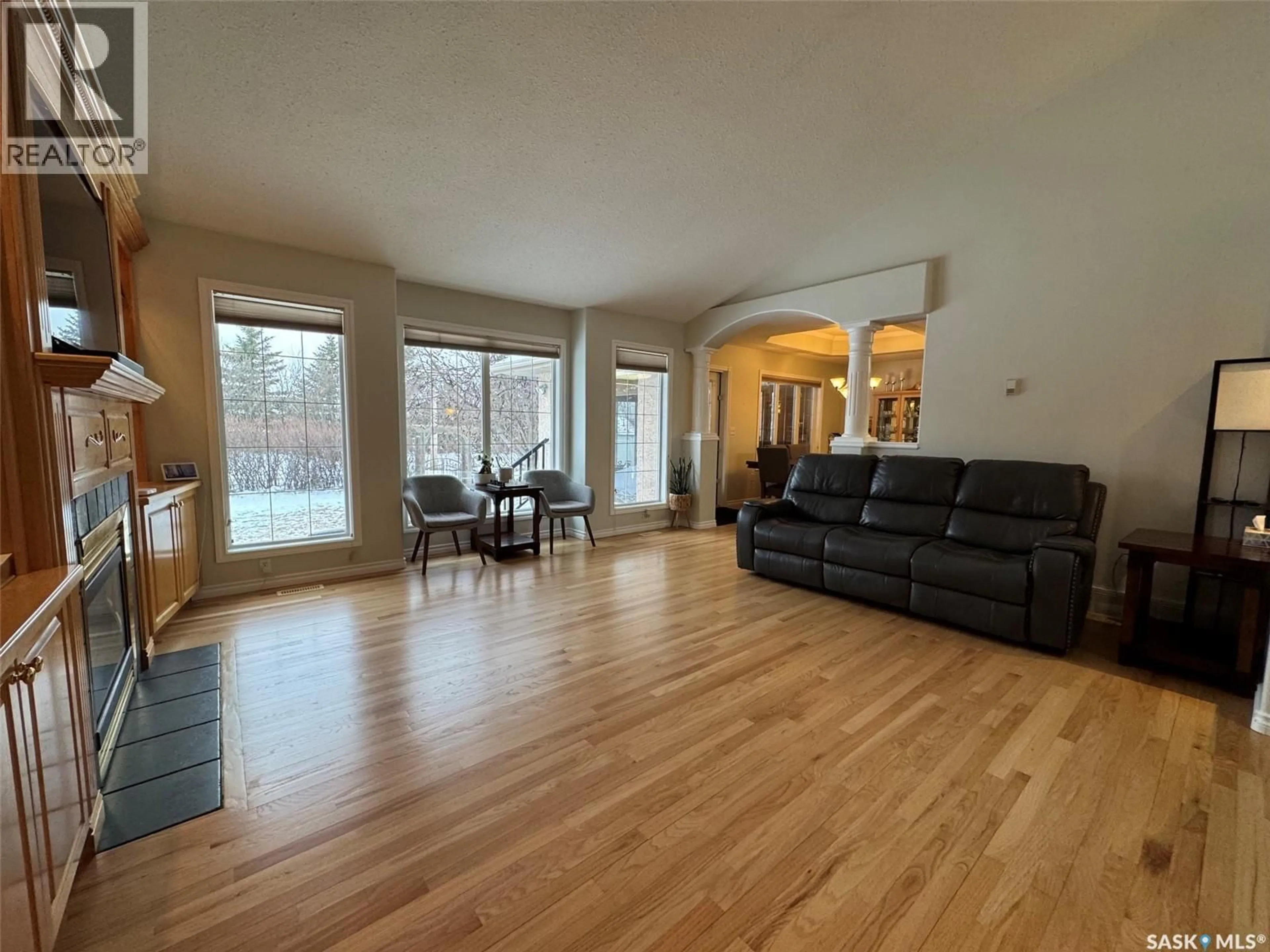 Living room with furniture, wood/laminate floor for 1211 21ST STREET, Humboldt Saskatchewan S0K2A0