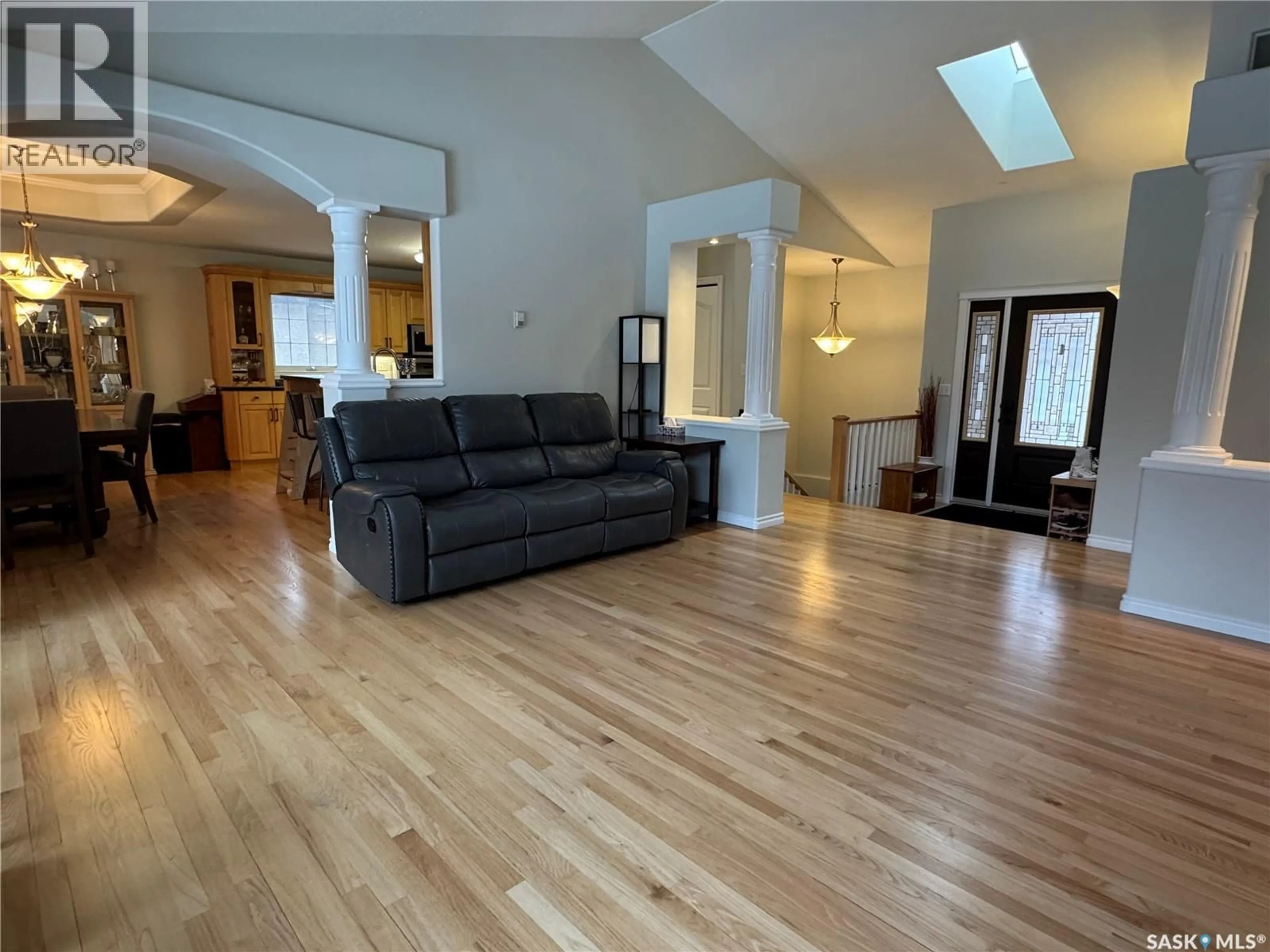 Living room with furniture, wood/laminate floor for 1211 21ST STREET, Humboldt Saskatchewan S0K2A0