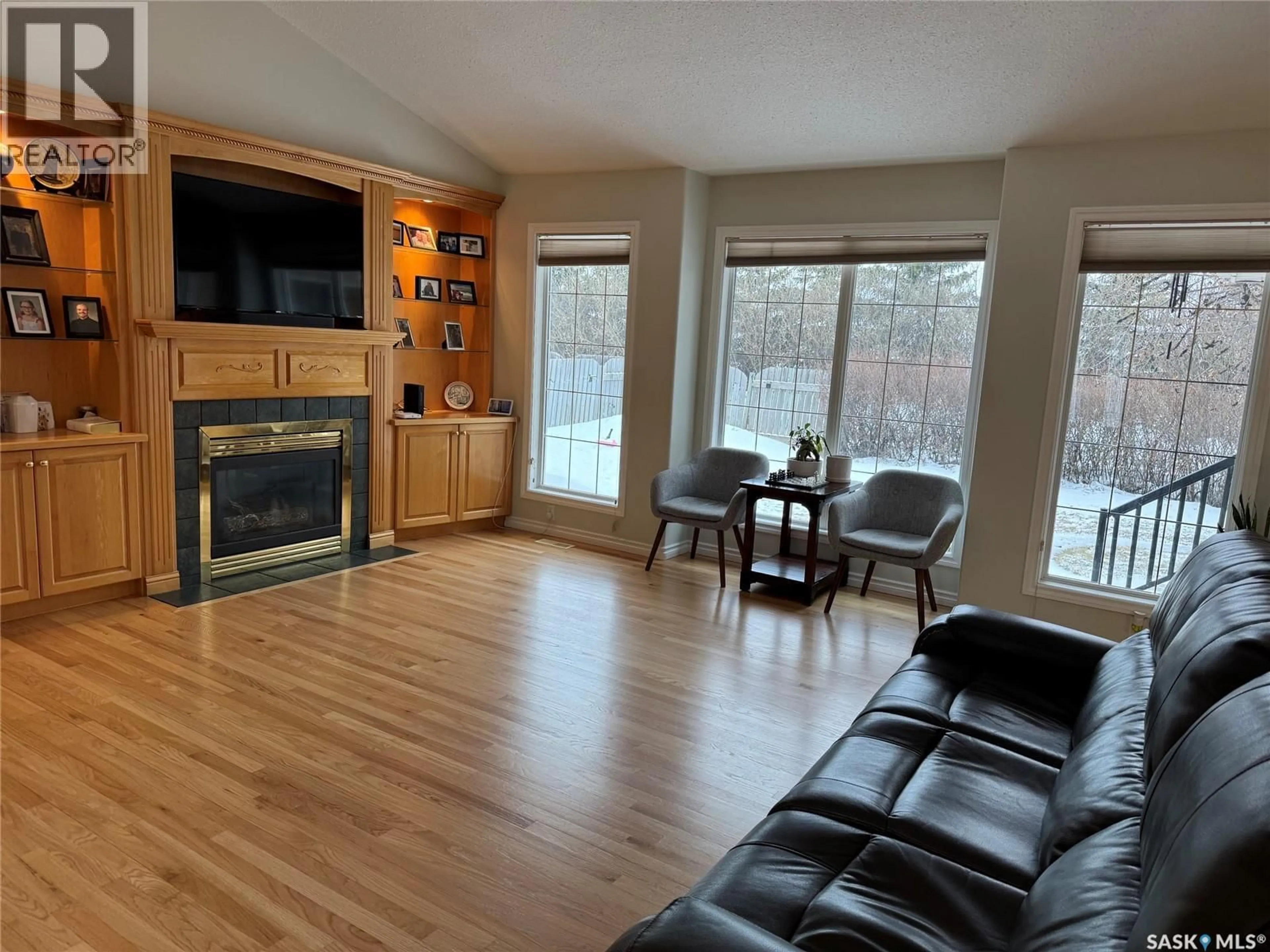 Living room with furniture, wood/laminate floor for 1211 21ST STREET, Humboldt Saskatchewan S0K2A0