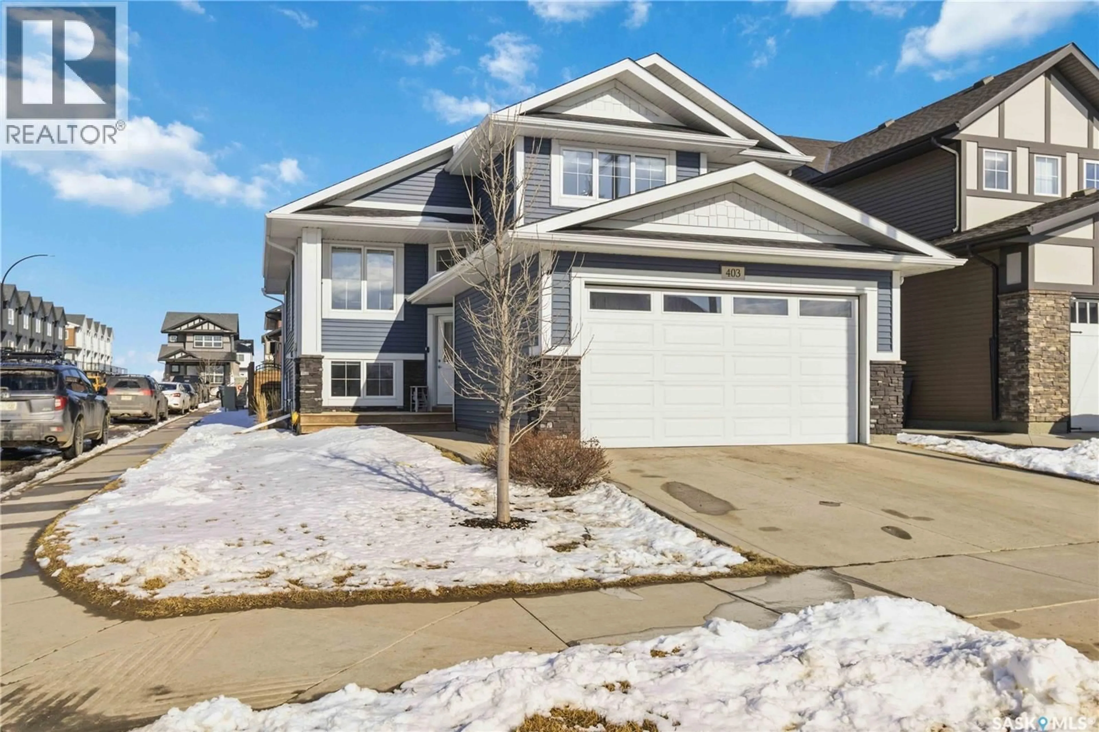 Home with vinyl exterior material, street for 403 DELAINEY ROAD, Saskatoon Saskatchewan S7V0N4