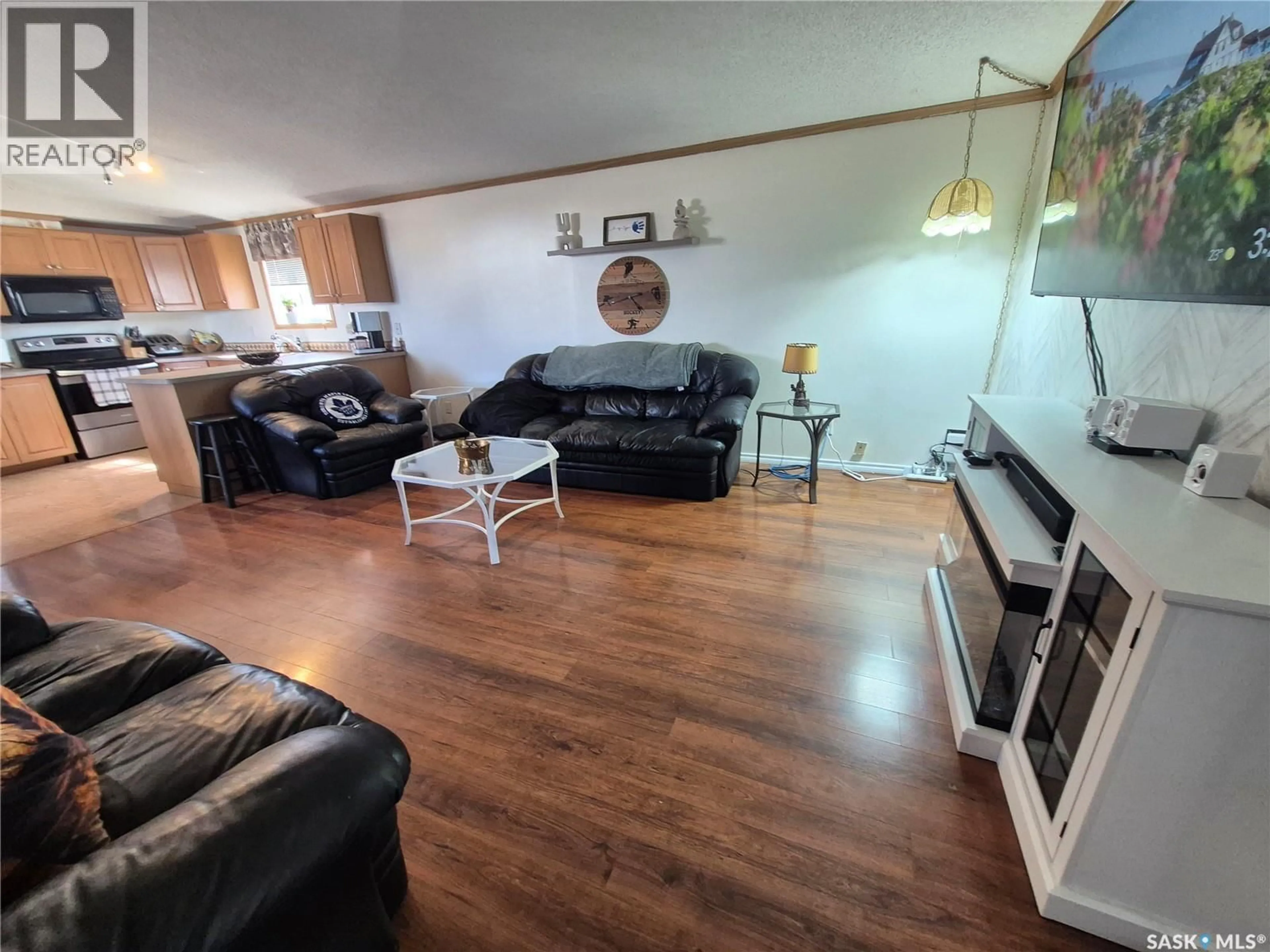 Living room with furniture, wood/laminate floor for 106 ALSIKE STREET, Yellow Grass Saskatchewan S0G5J0