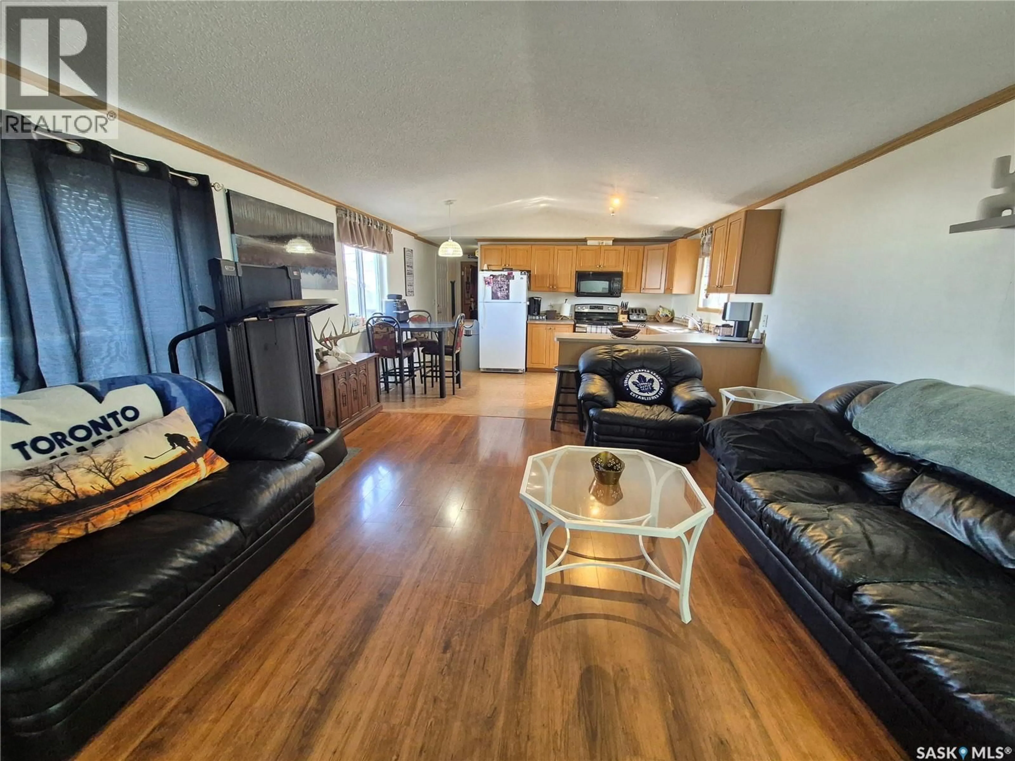 Living room with furniture, wood/laminate floor for 106 ALSIKE STREET, Yellow Grass Saskatchewan S0G5J0
