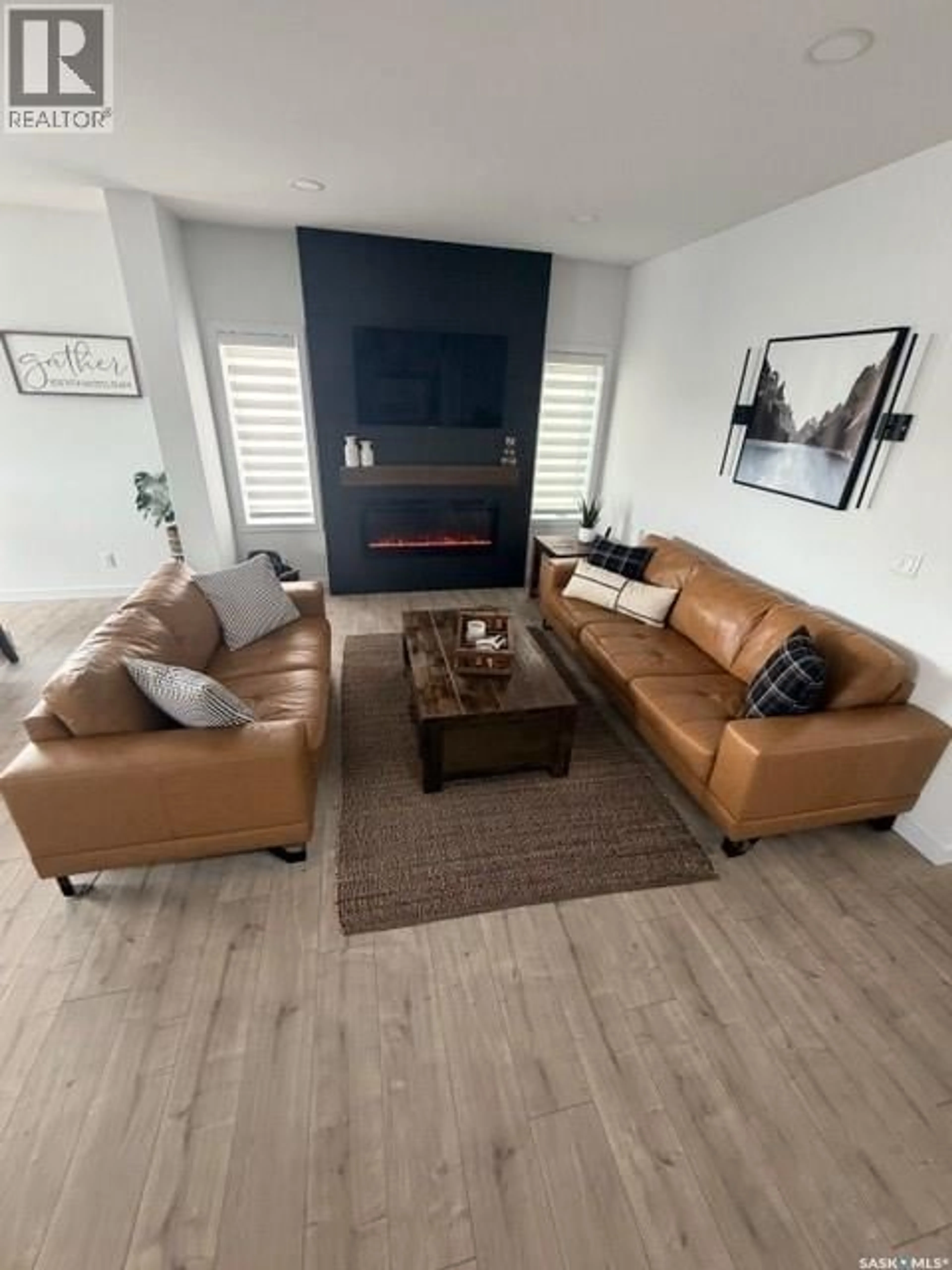 Living room with furniture, wood/laminate floor for 351 ANISKOTAW BEND, Saskatoon Saskatchewan S7V1M1