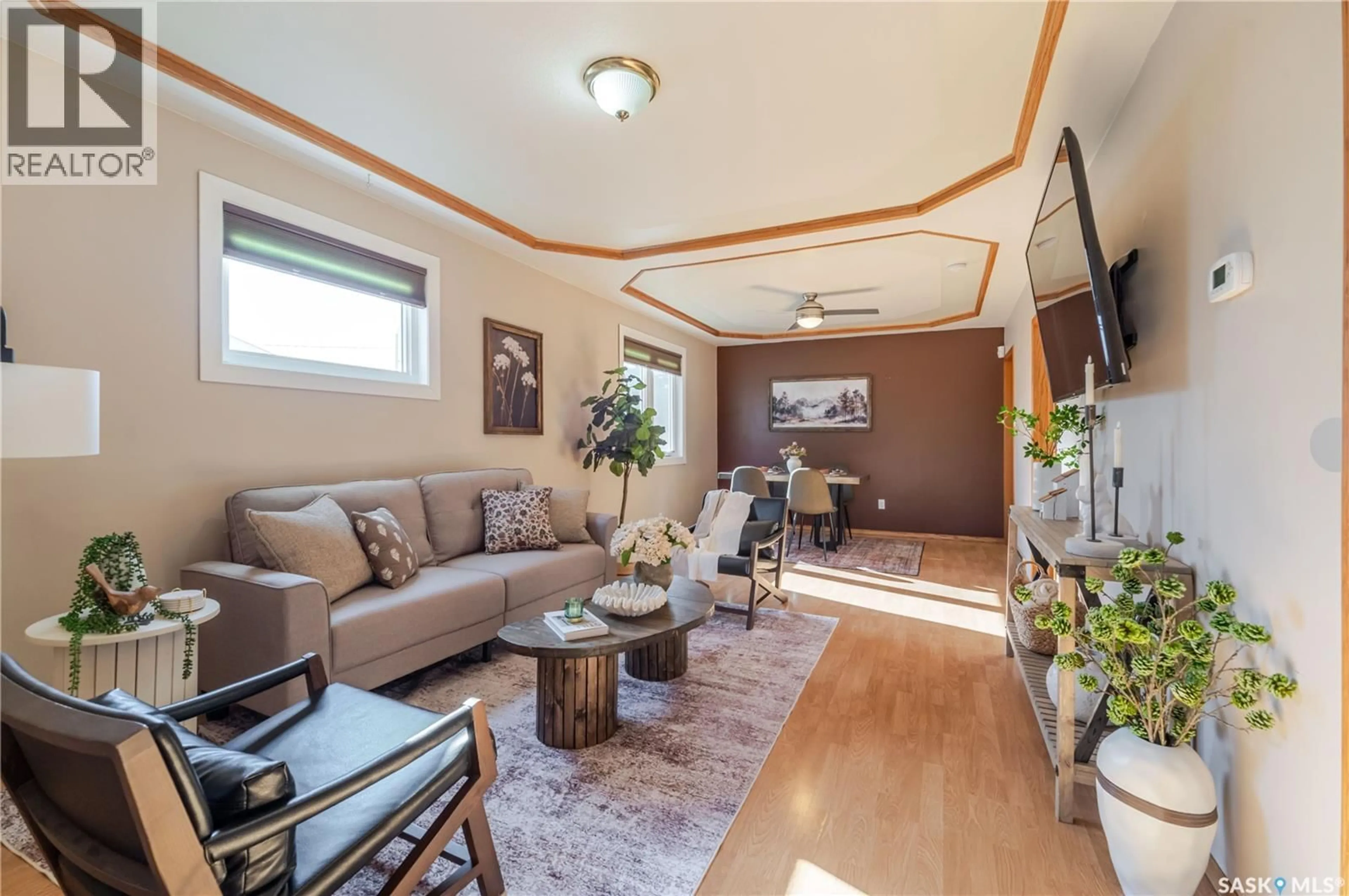 Living room with furniture, wood/laminate floor for 1117 IROQUOIS STREET, Moose Jaw Saskatchewan S6H5C1