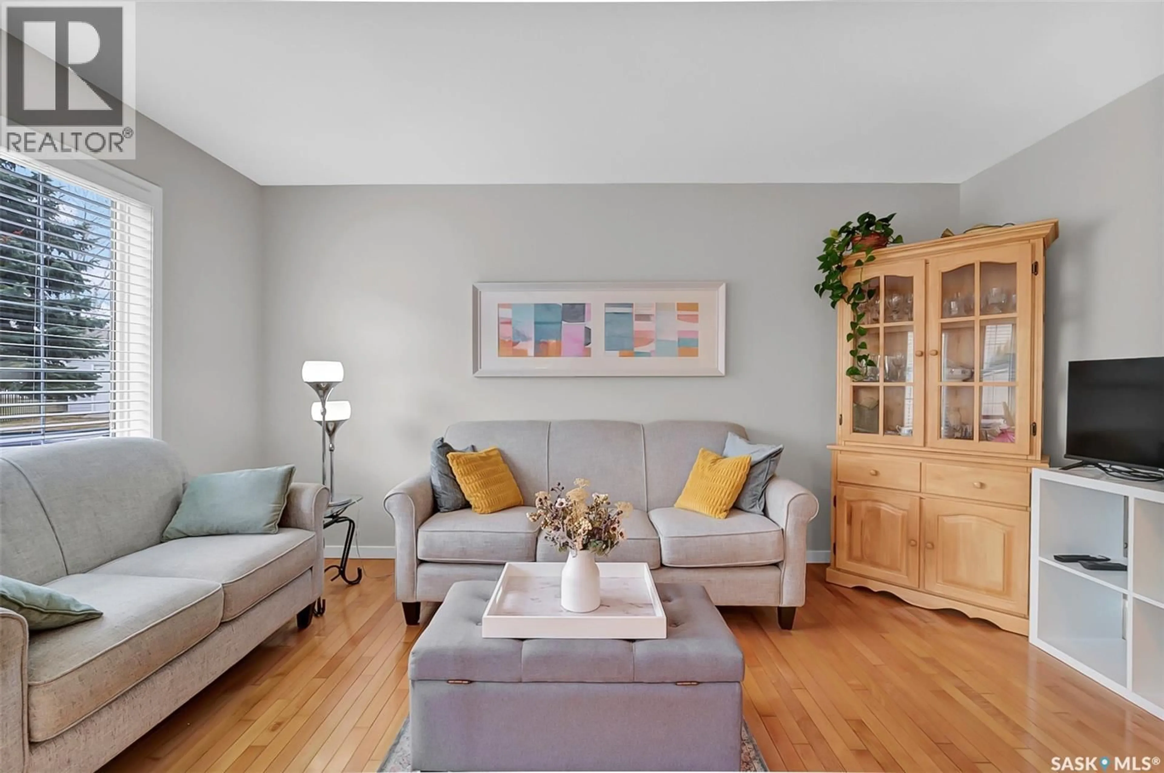 Living room with furniture, wood/laminate floor for 615 - 206 KENDERDINE ROAD, Saskatoon Saskatchewan S7N4V1