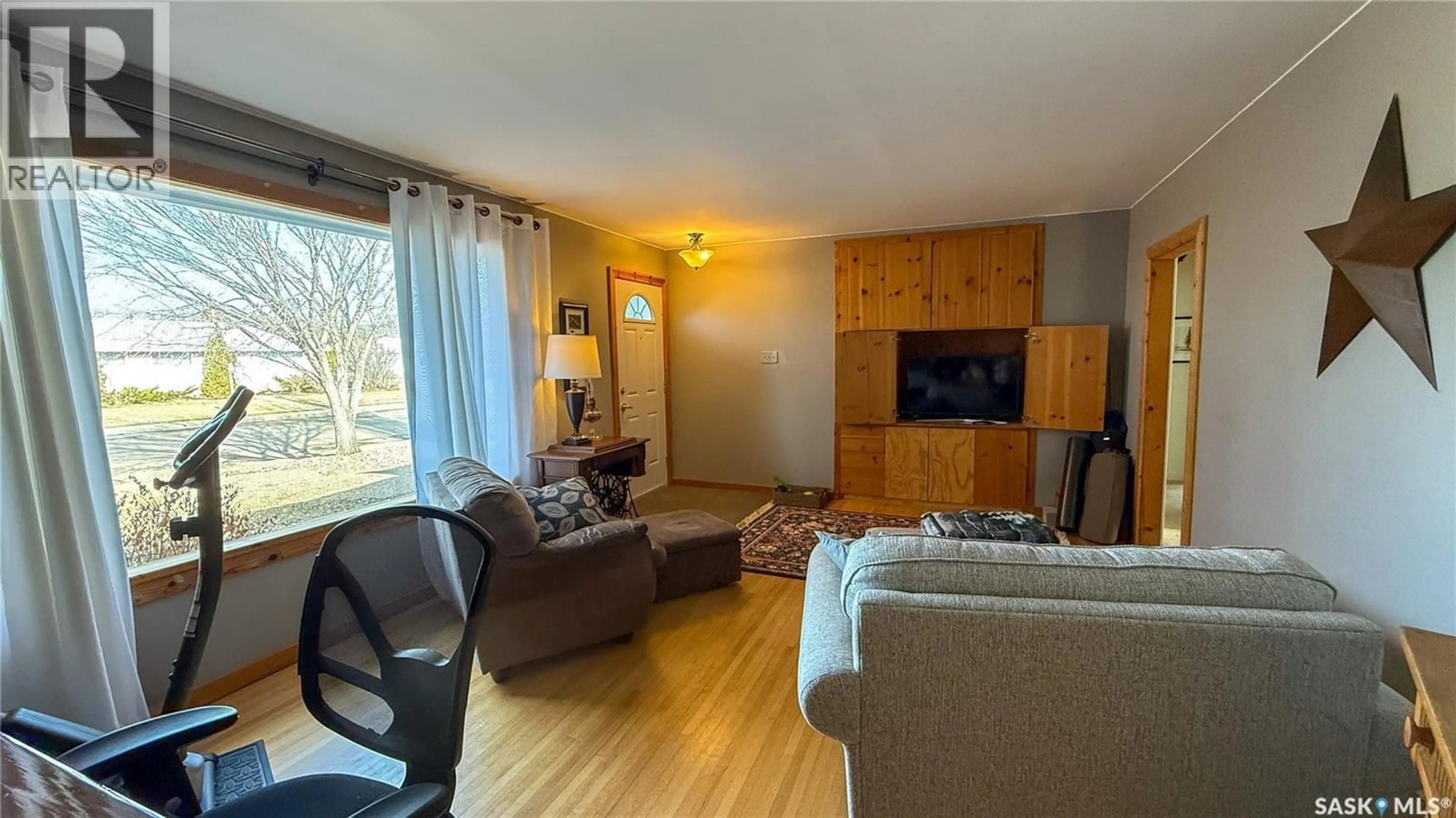 Living room with furniture, wood/laminate floor for 1752 93RD STREET, North Battleford Saskatchewan S9A0C8